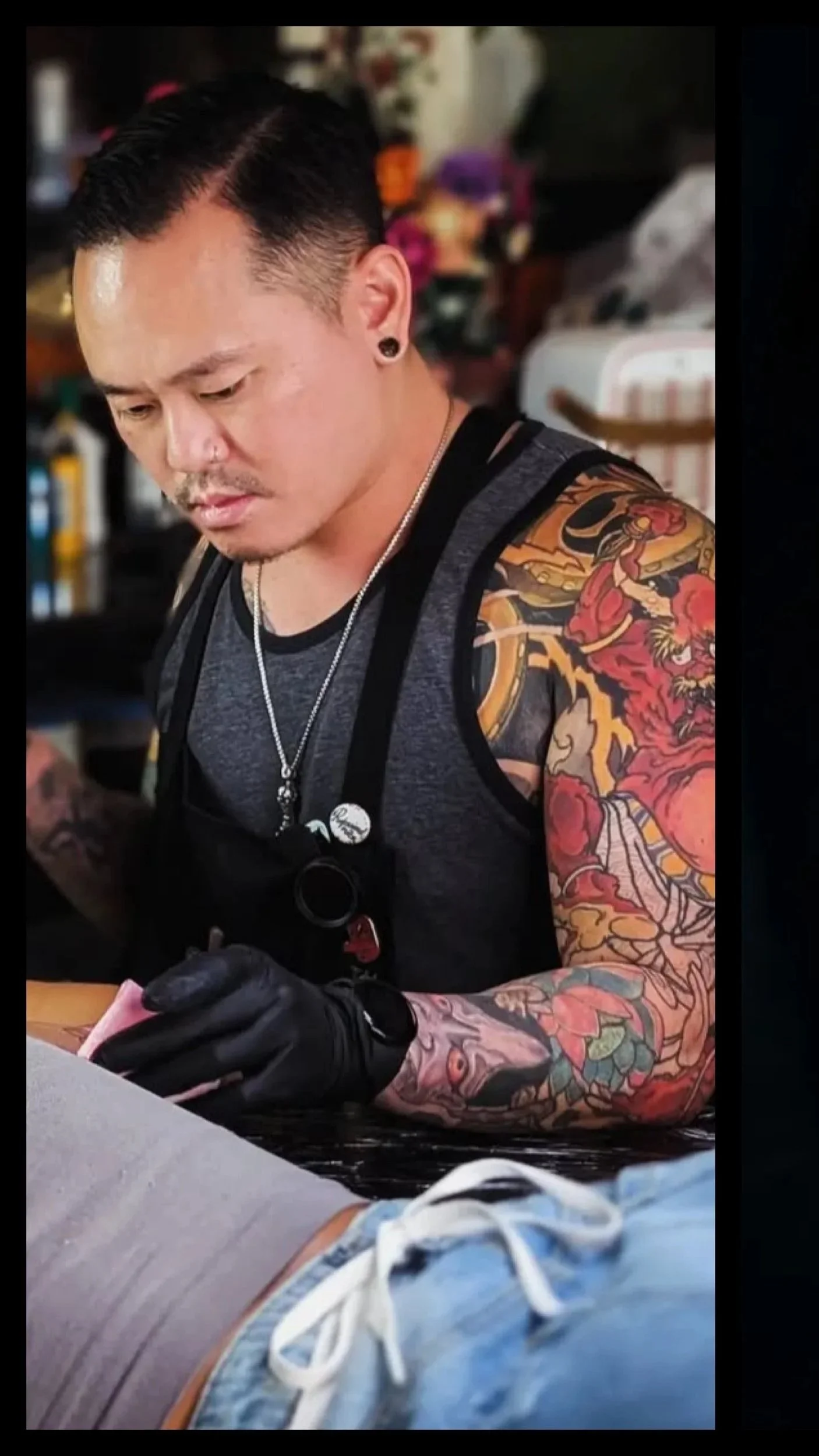 Zach Yokoyama of Black Cat Tattoo Honolulu tattooing a client