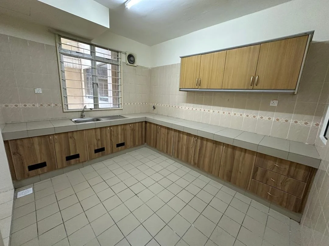 Empty kitchen with beige tiled walls, wooden cabinets, a window above the sink, and a tiled floor.