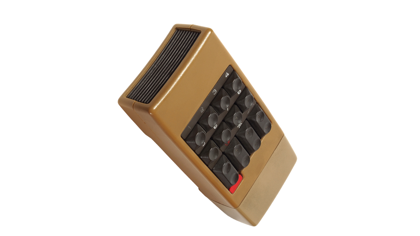 A vintage electronic calculator with a beige plastic body and black buttons, featuring a small solar panel at the top.