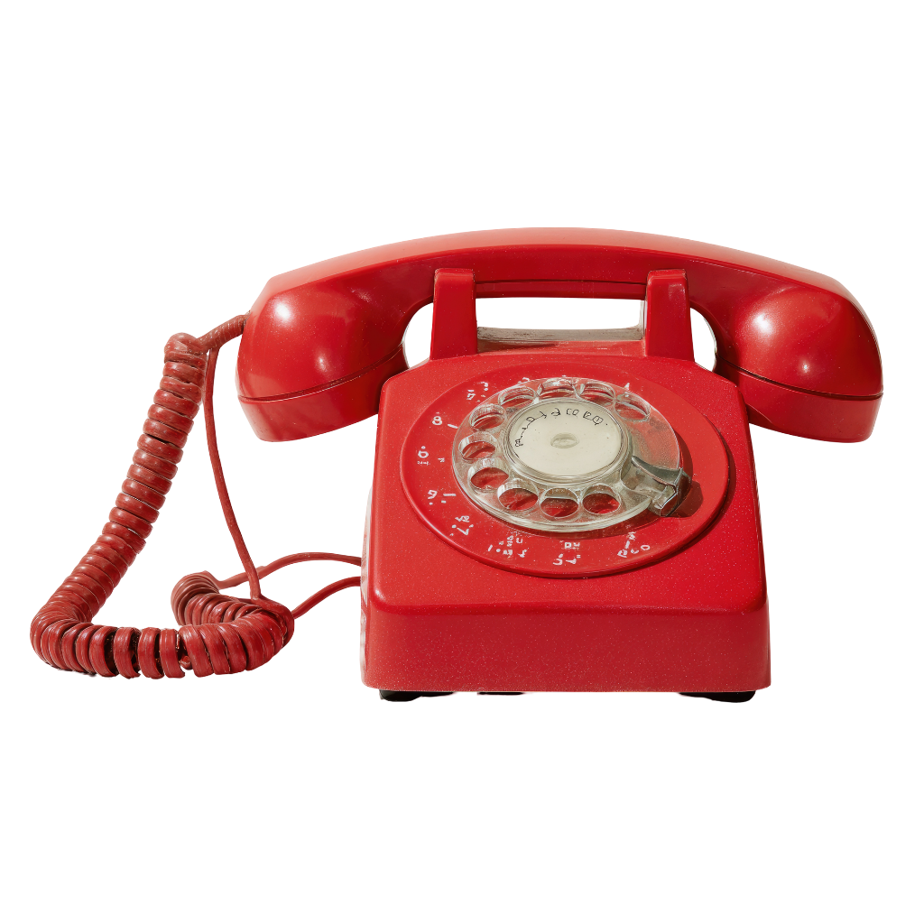 Red rotary dial telephone with a coiled cord and a circular dial pad, isolated on a black background.