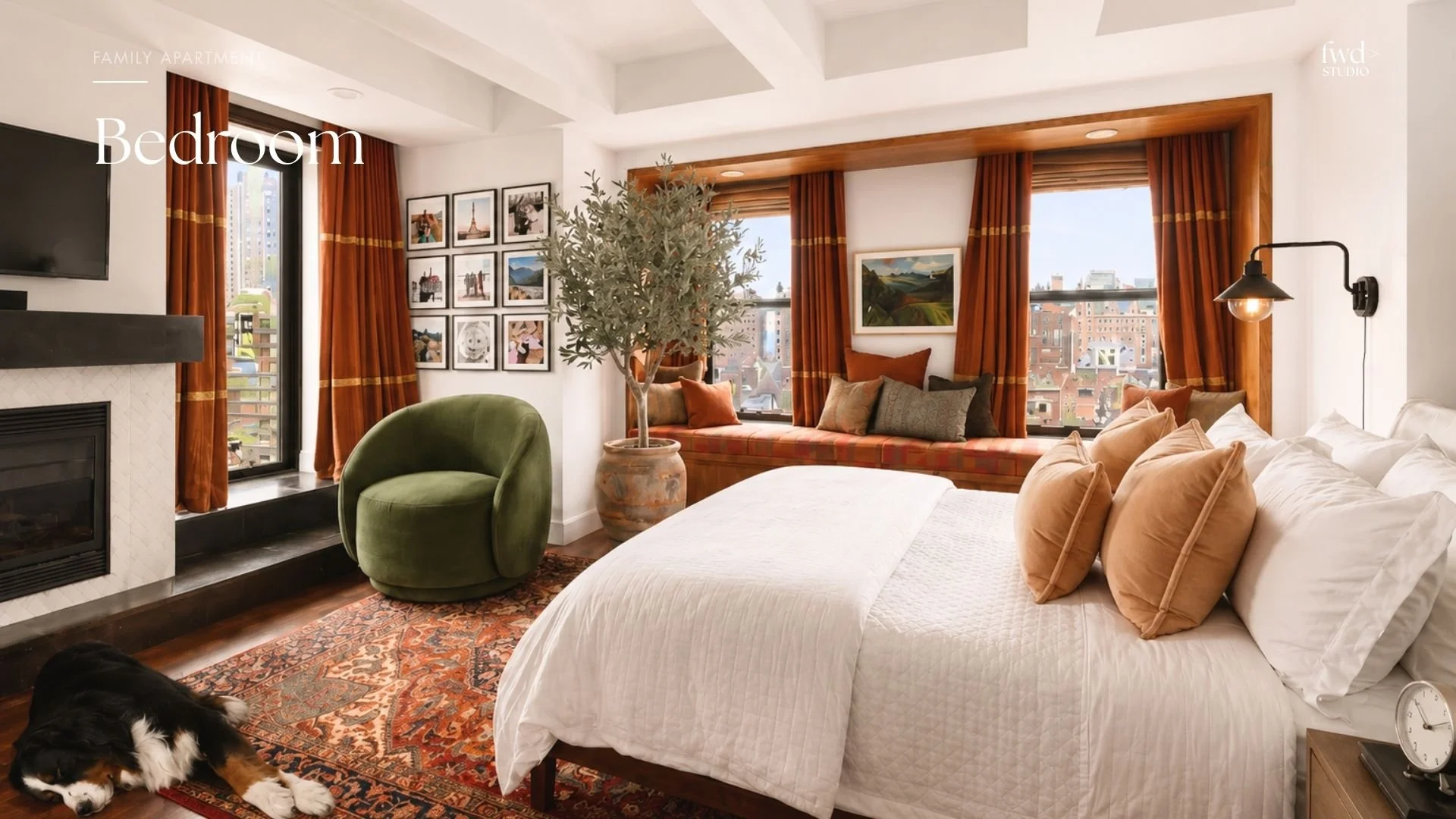 A cozy bedroom with a large bed, beige pillows, a window seat with cushions, and several windows with orange curtains showing a cityscape outside. There is a green chair, a potted plant, a wall-mounted lamp, a fireplace, and a gallery wall of photos.