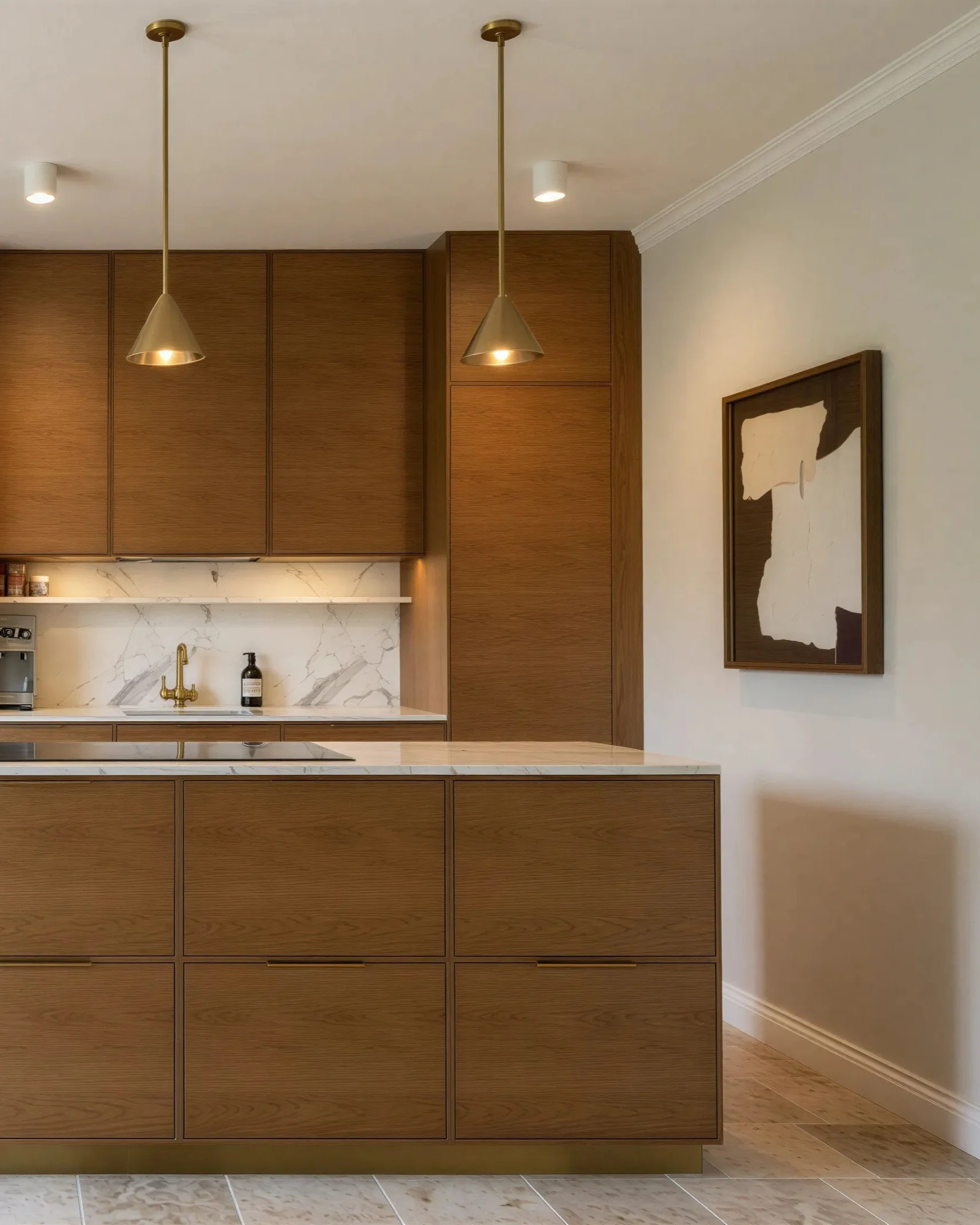 Modern kitchen with wooden cabinets, marble backsplash, and brass pendant lights hanging from the ceiling.