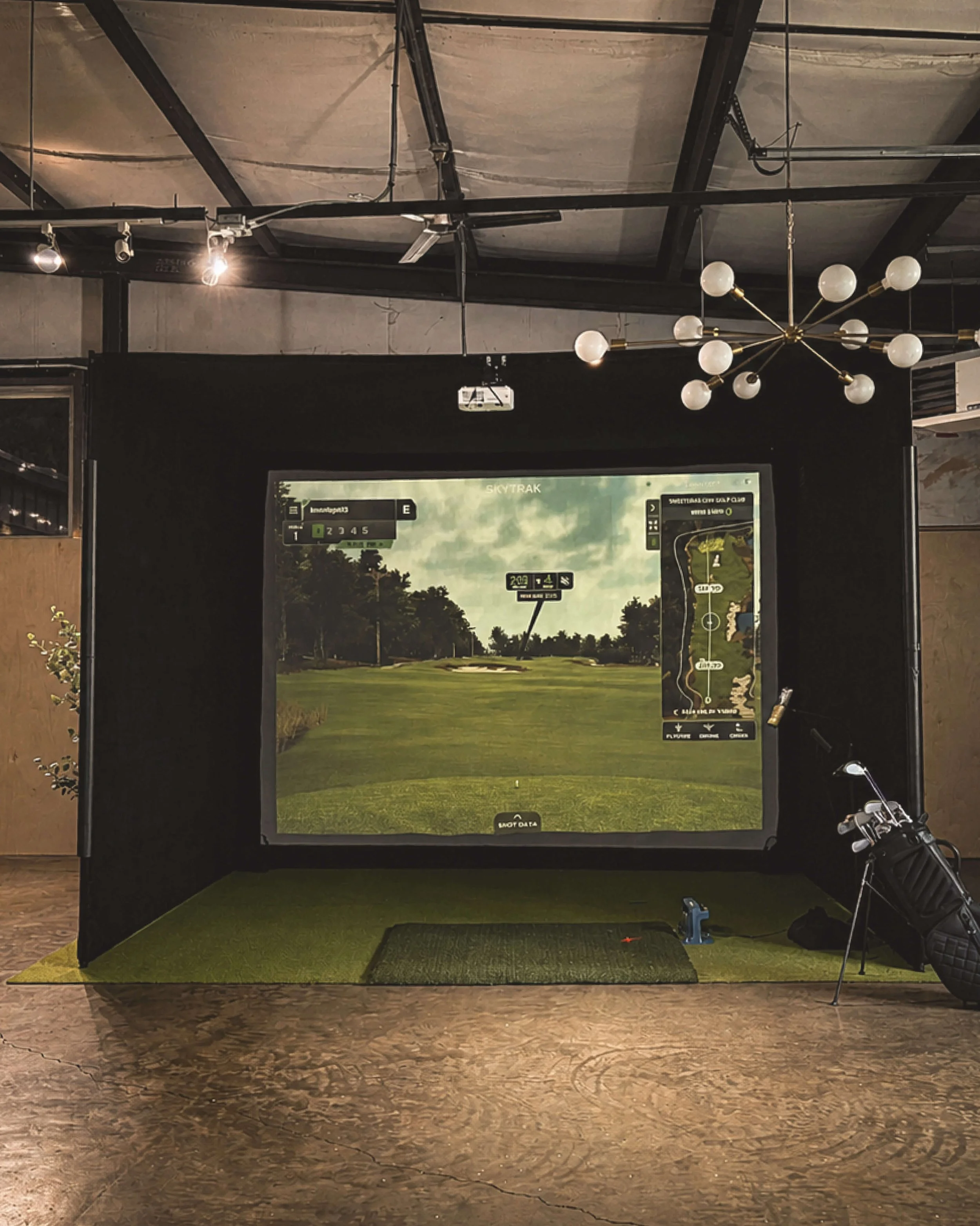 Lemont Golf mobile simulator setup inside a Nashville corporate event venue with track lighting