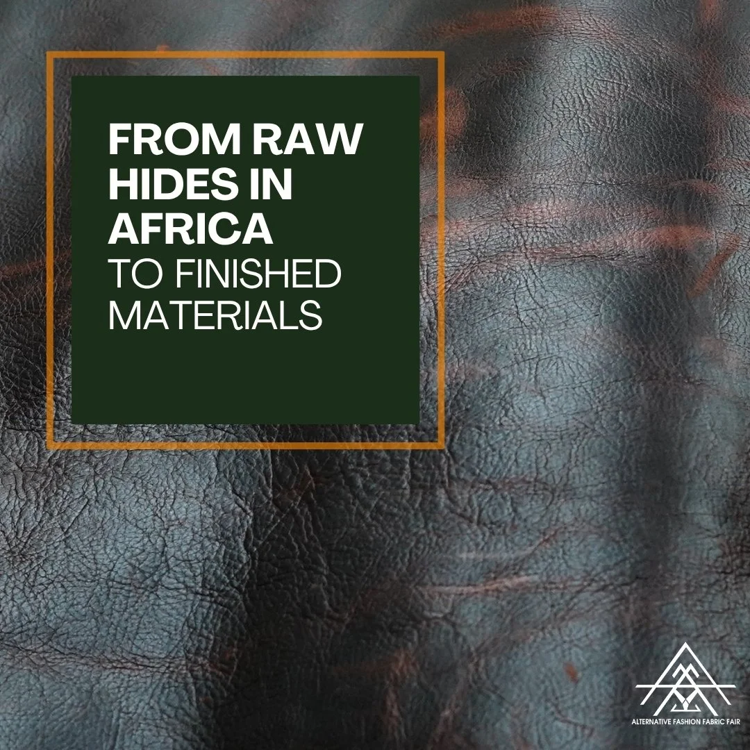 Close-up image of textured black leather with a green rectangle containing white text and an orange border overlay. The text reads, "From raw hides in Africa to finished materials." In the bottom right corner, there is a white logo of a triangle with