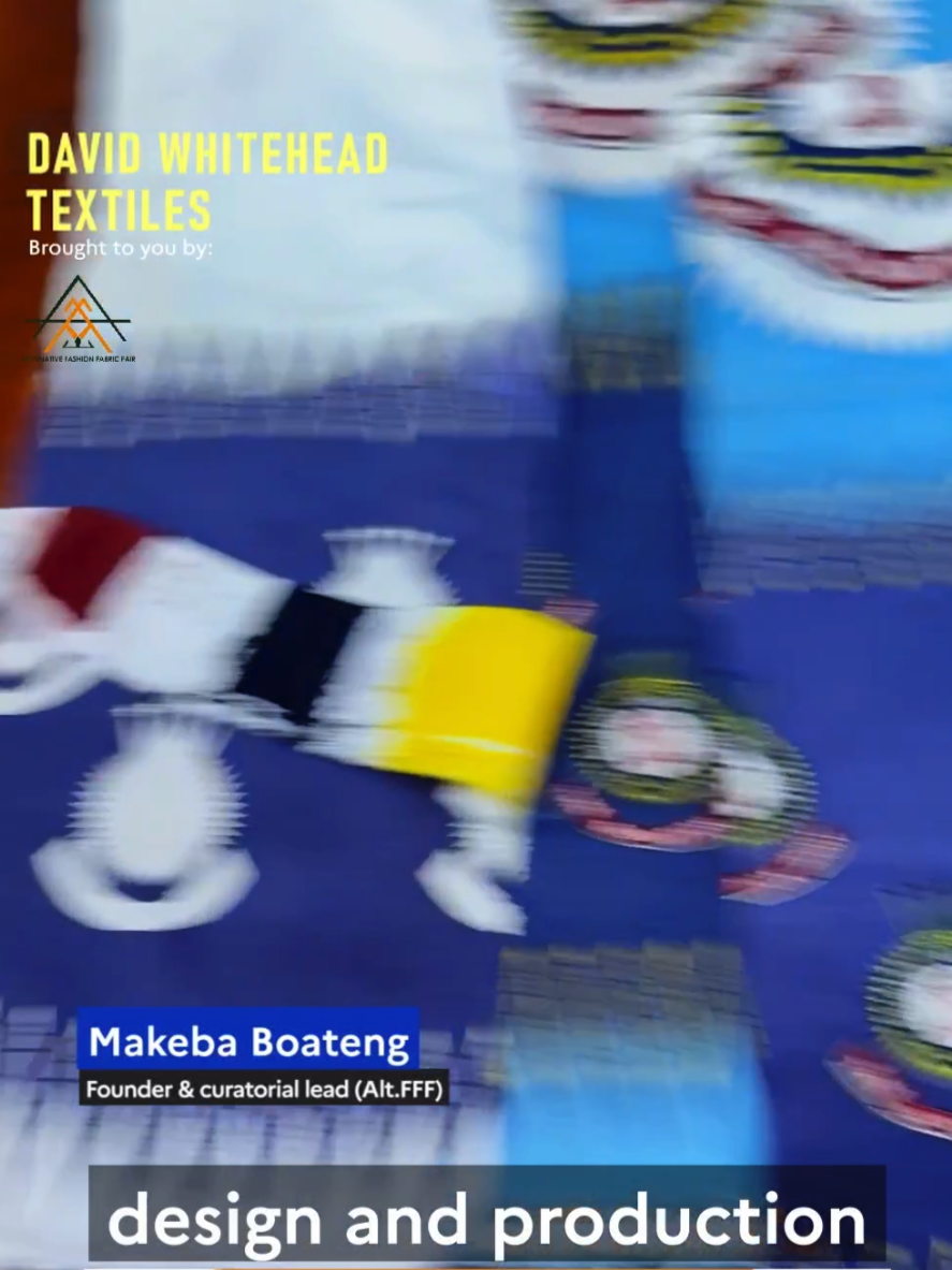 Blurred image of promotional banner for David Whitehead Textiles at the Creative Fashion Fabric Fair featuring colorful fabric samples and text mentioning Makeba Boateng, founder and curatorial lead.