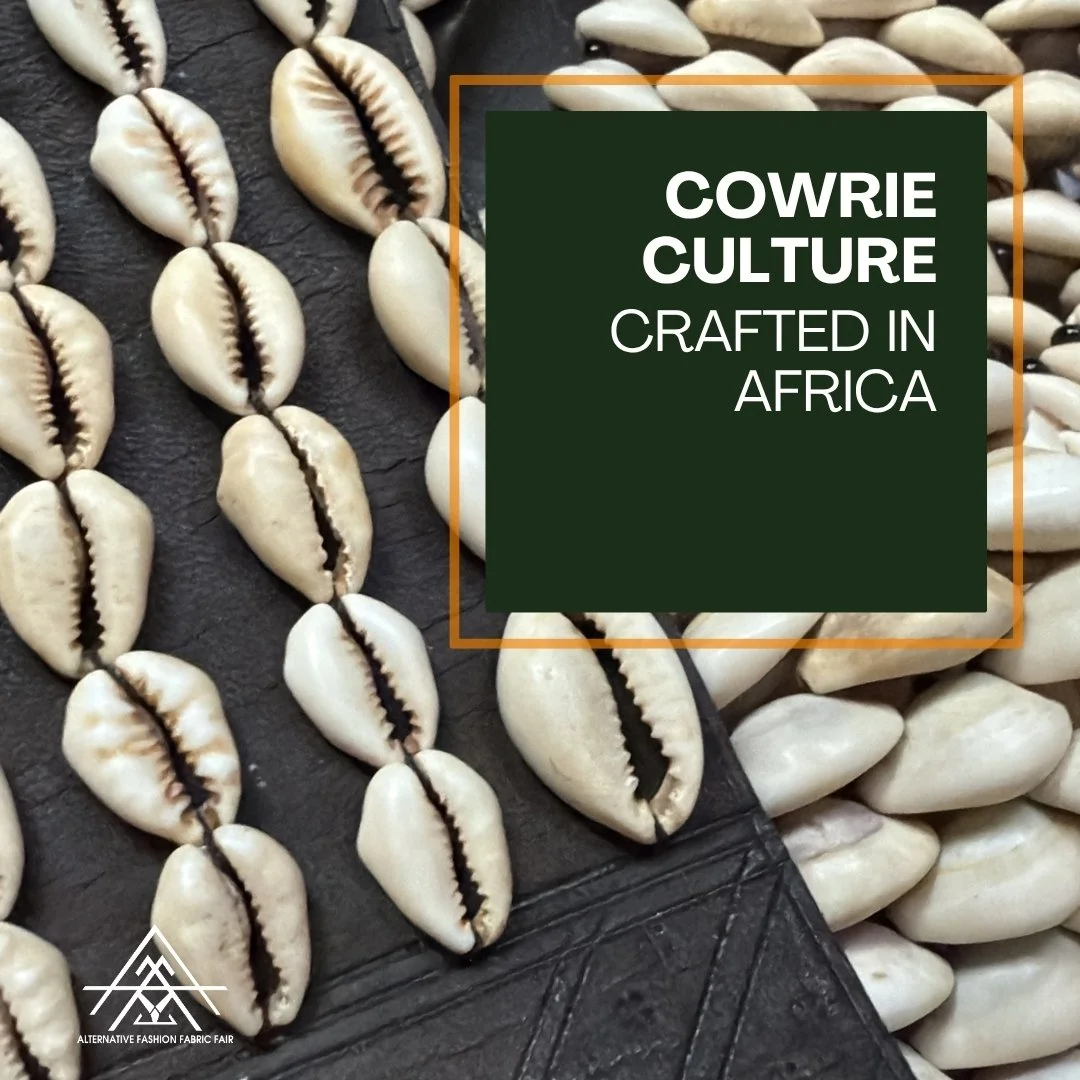 Close-up of cowrie shells arranged on a surface with a text overlay reading 'Cowrie Culture Crafted in Africa' and a logo for the Alternative Fashion Fabric Fair.