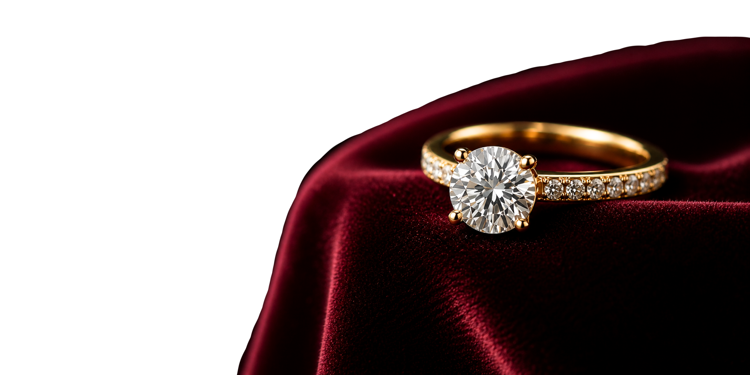 A gold ring with a large central diamond and smaller diamonds along the band, placed on red velvet fabric.