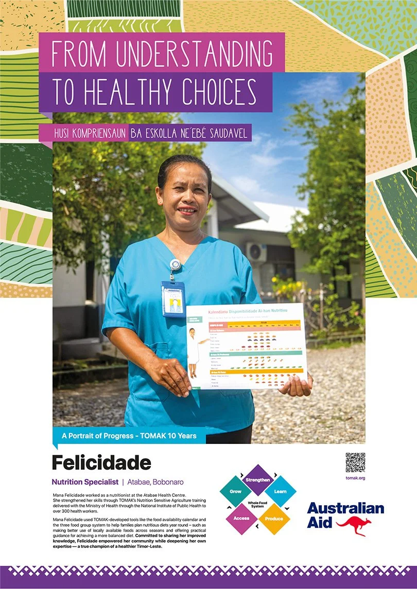 A woman in blue scrubs holding a colorful nutrition calendar outdoors, with trees and a building in the background, promoting nutrition and health progress.