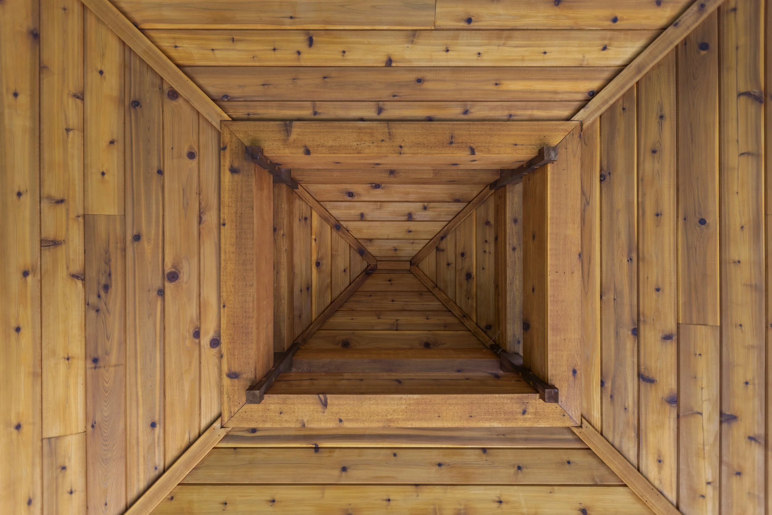 Wooden ceiling and walls, view looking up inside a wooden structure or room.