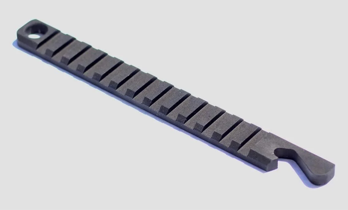Tactical bottle opener with rail-style slots, machined from 6061 aluminum with a black anodized finish