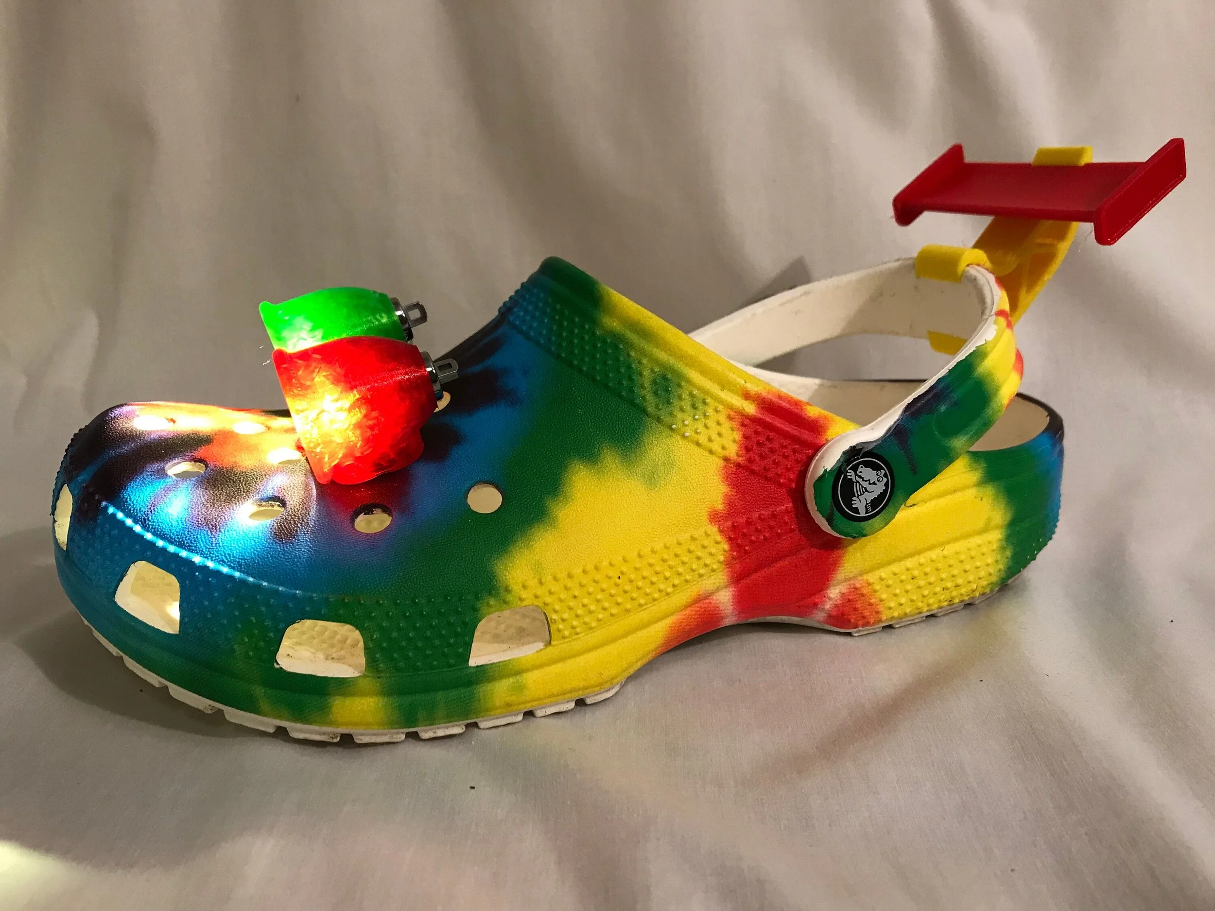 Tie-dye Croc with a red rear spoiler and a light-up charm