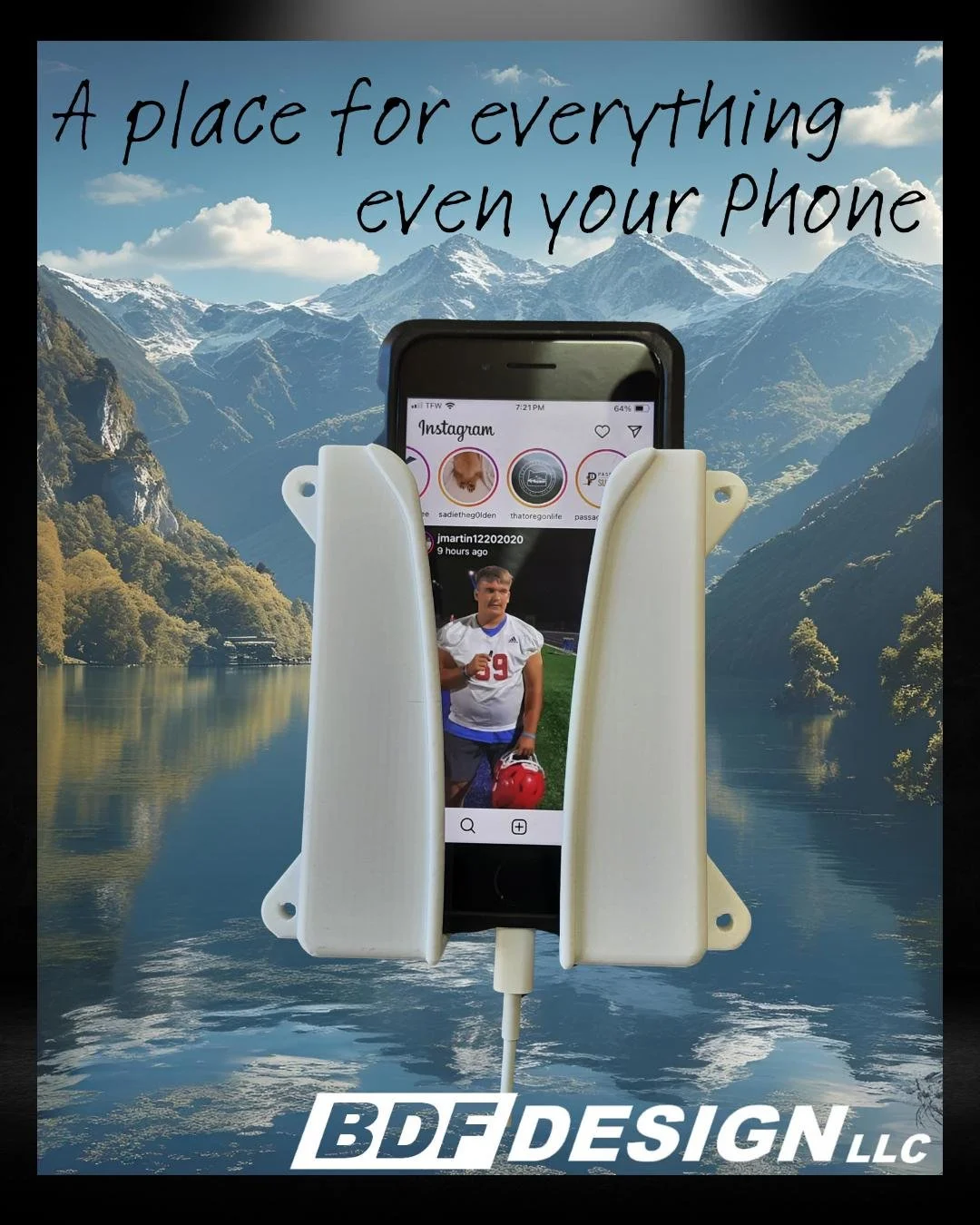 White 3D-printed phone holder with a smartphone charging in it, mounted on a wall