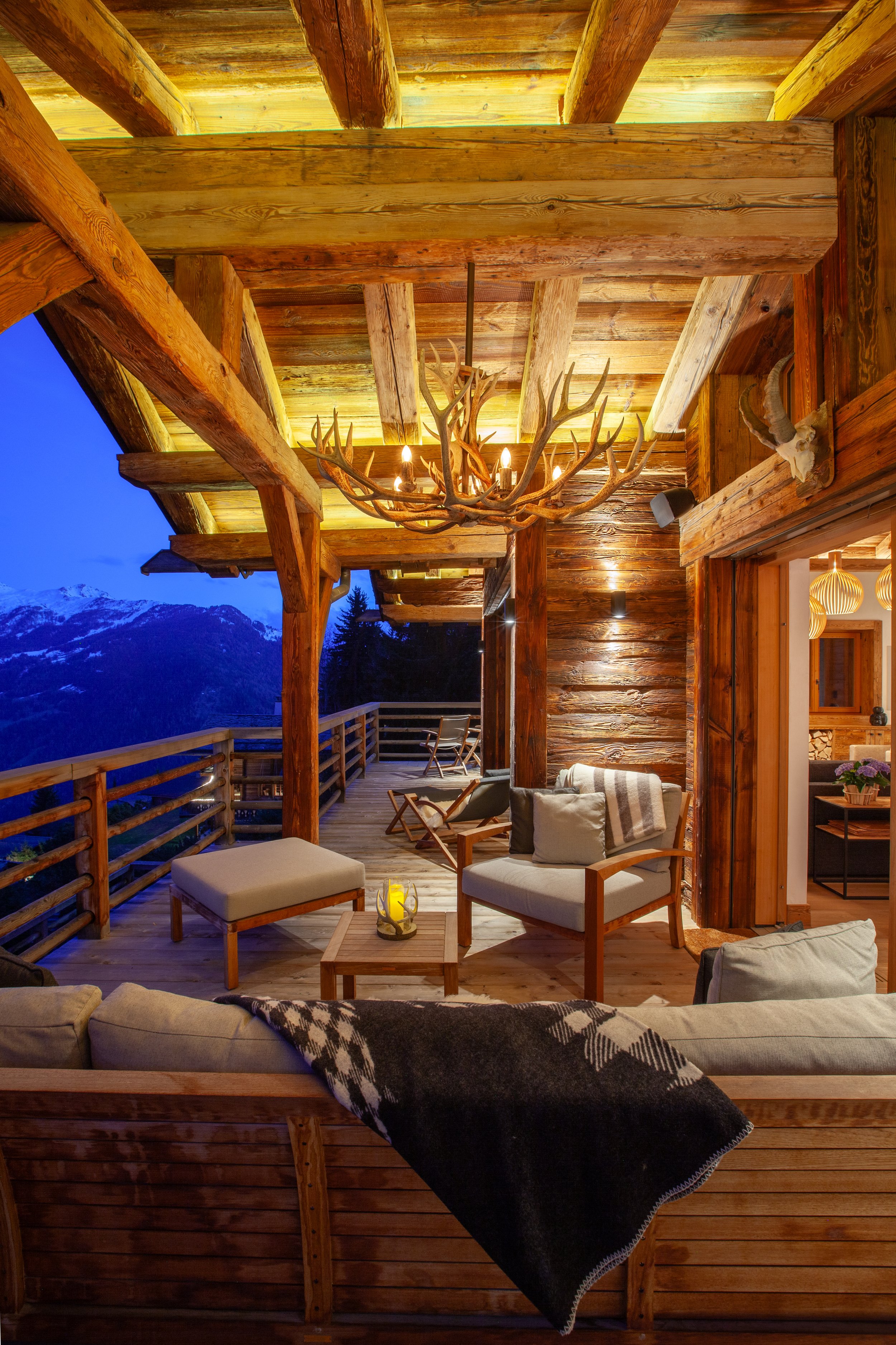 Big Mountain Antlers antler chandelier on covered terrace with Royal Botania furniture and Alpine mountain views, Chalet la Vigne Verbier Switzerland