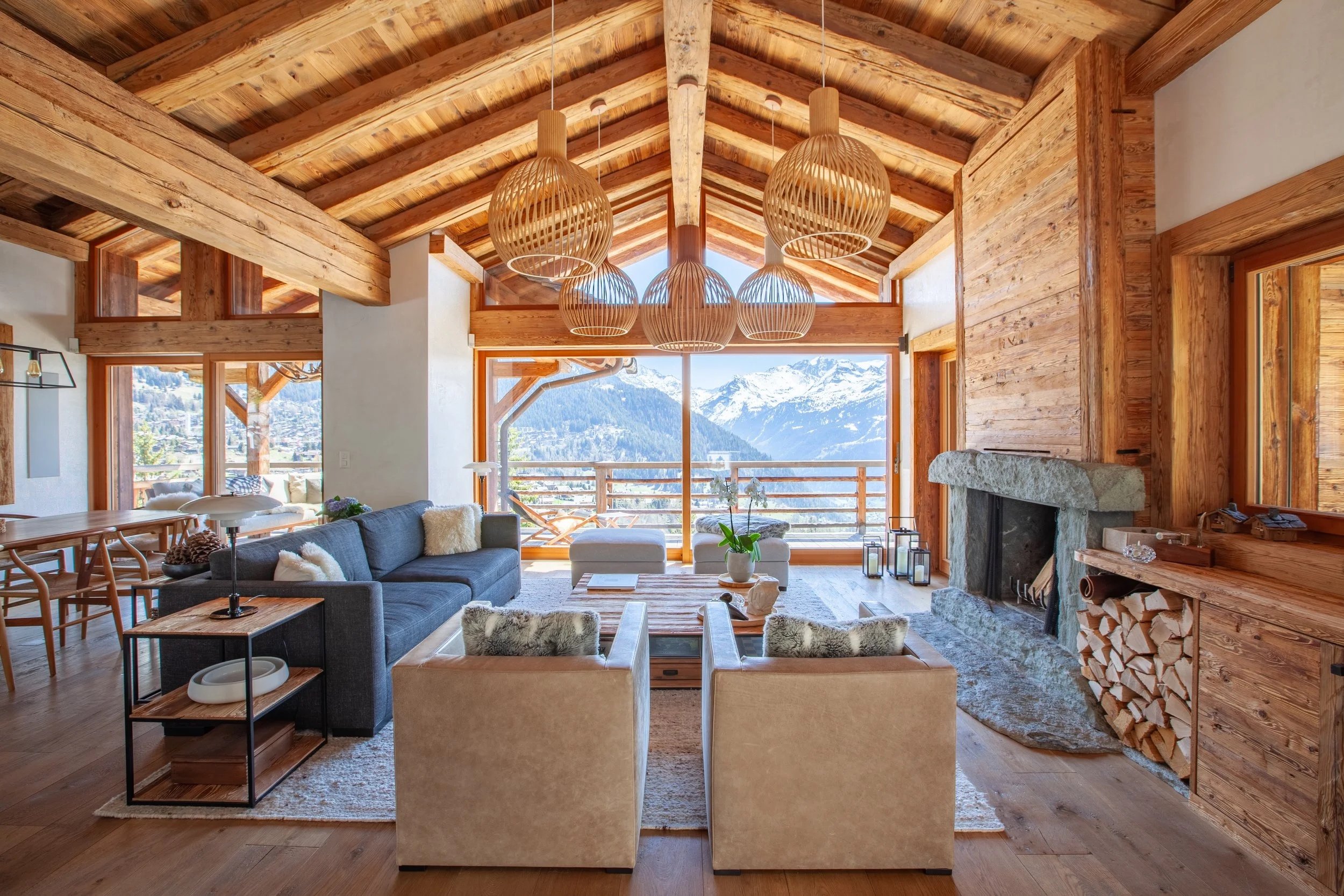 Luxury chalet living room with Meridiani furniture, Secto Design and Louis Poulsen lighting, fur throws and panoramic Alpine views, Chalet la Vigne Verbier Switzerland