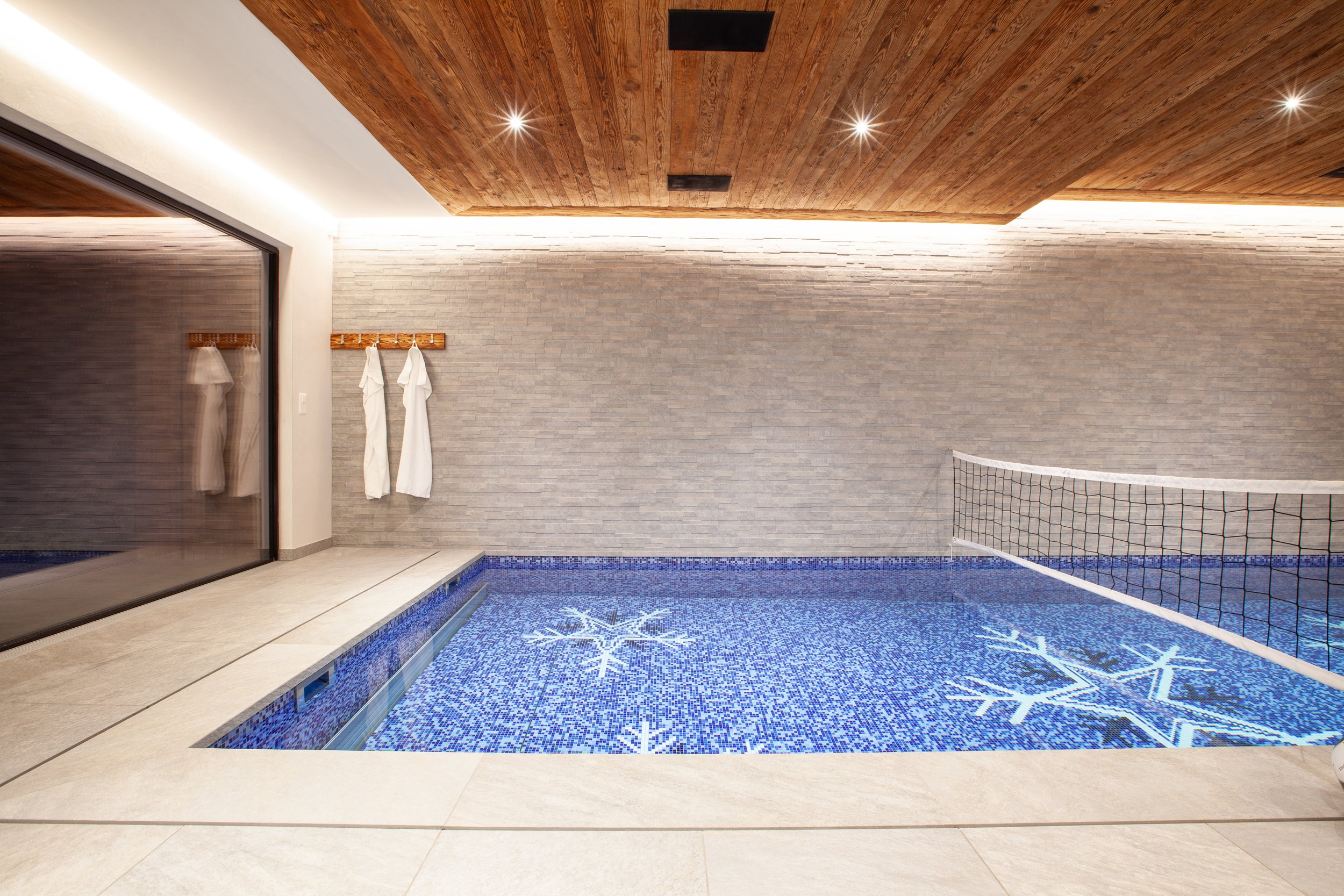 Indoor swimming pool with towels, Chalet la Vigne Verbier luxury ski chalet Switzerland