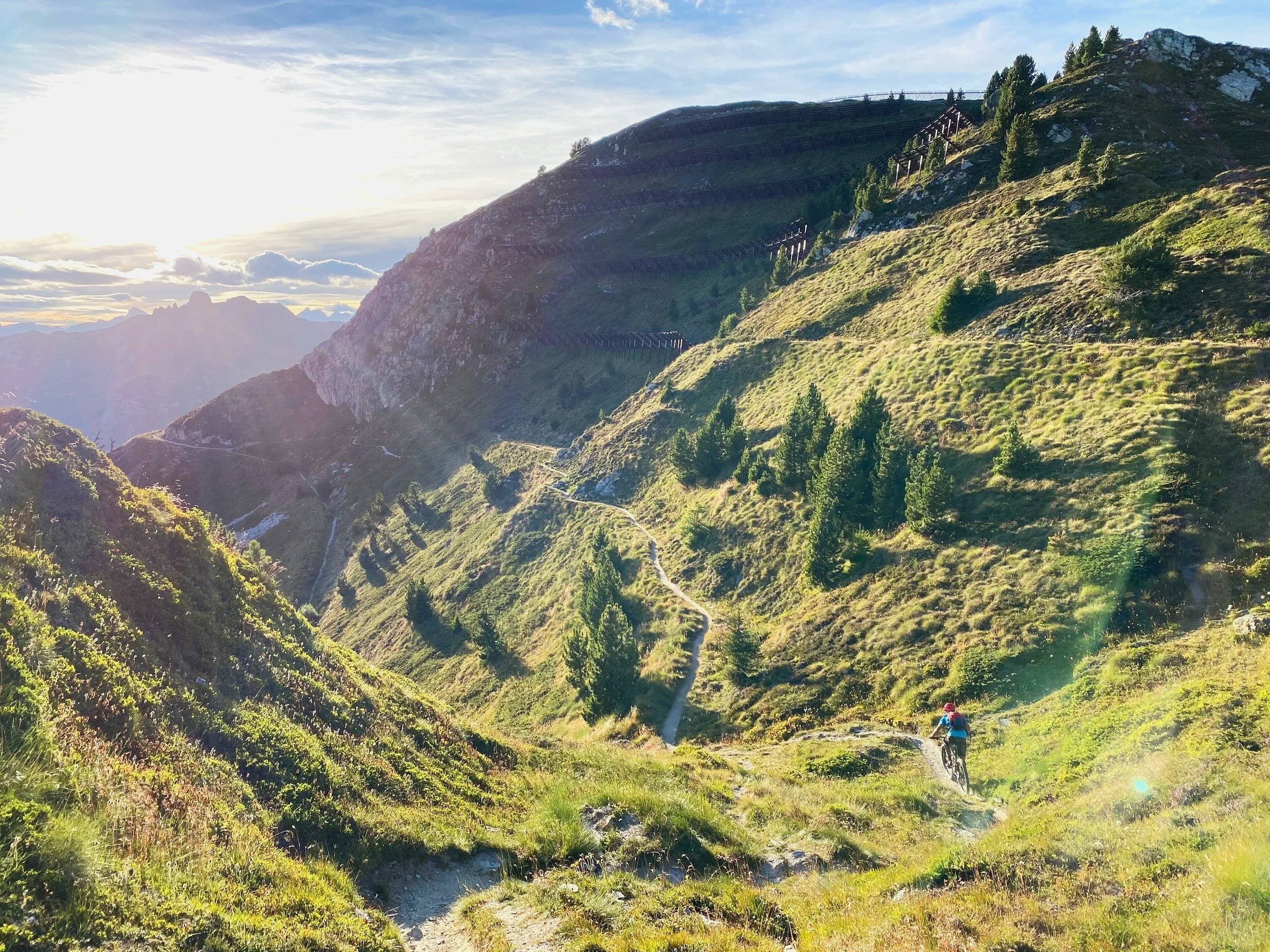 Mountain biker on singletrack high above Verbier at sundown, Switzerland