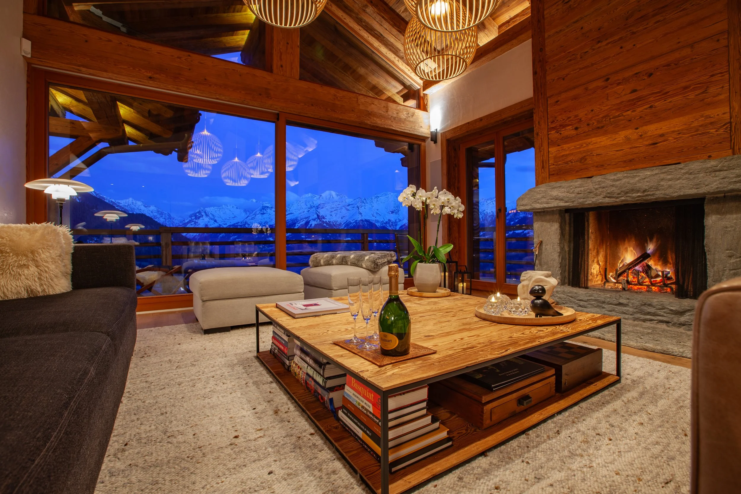 Ruinart champagne beside roaring fire with panoramic Alpine mountain views, Chalet la Vigne Verbier luxury ski chalet Switzerland