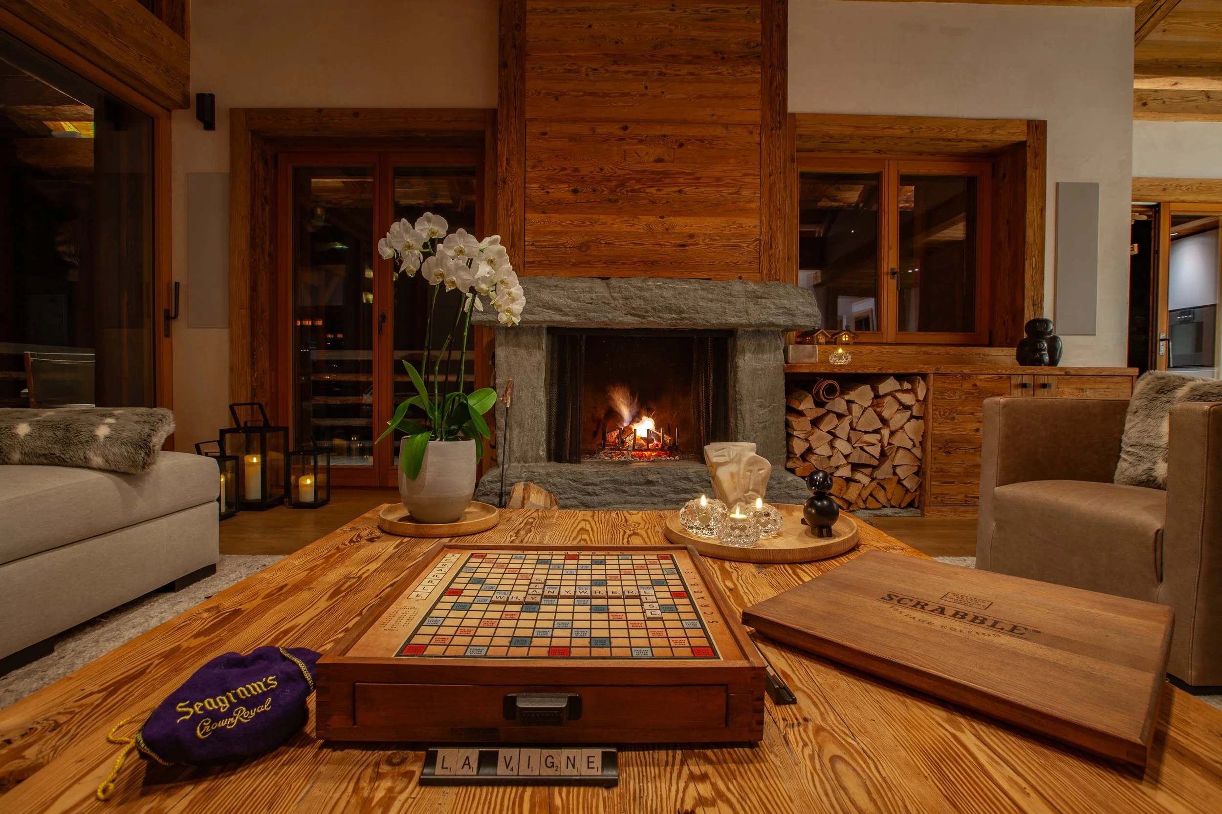 Scrabble board by roaring fire, cosy evening at Chalet la Vigne Verbier luxury ski chalet Switzerland