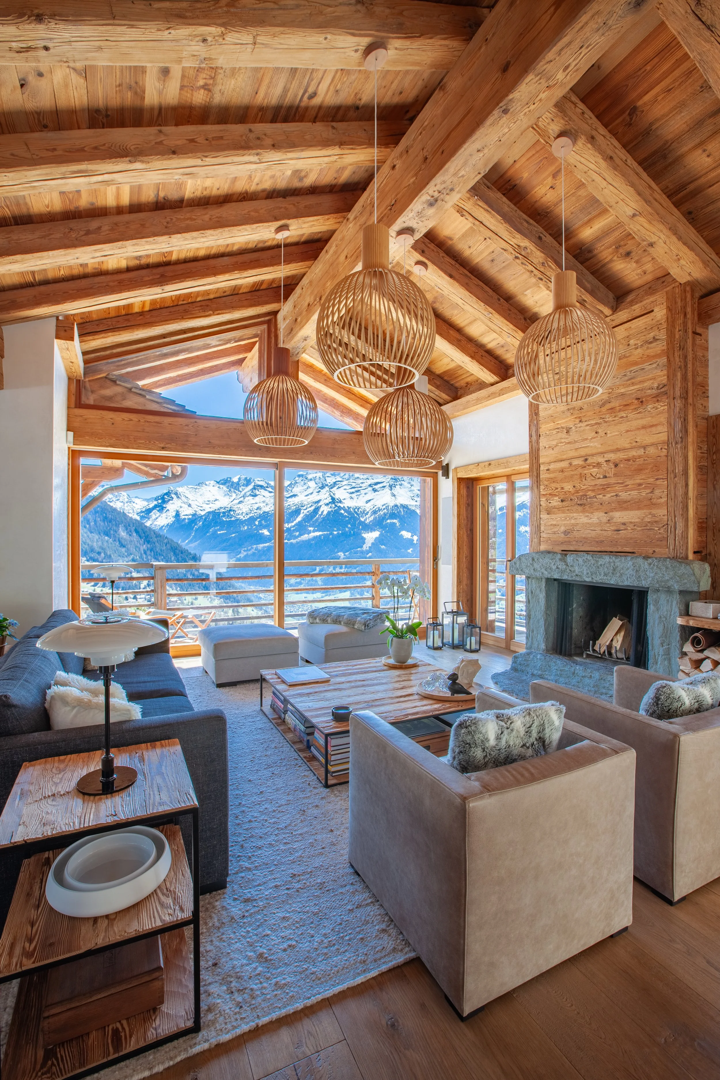 Chalet la Vigne Verbier living room with open fire and Alpine views, luxury ski chalet Switzerland