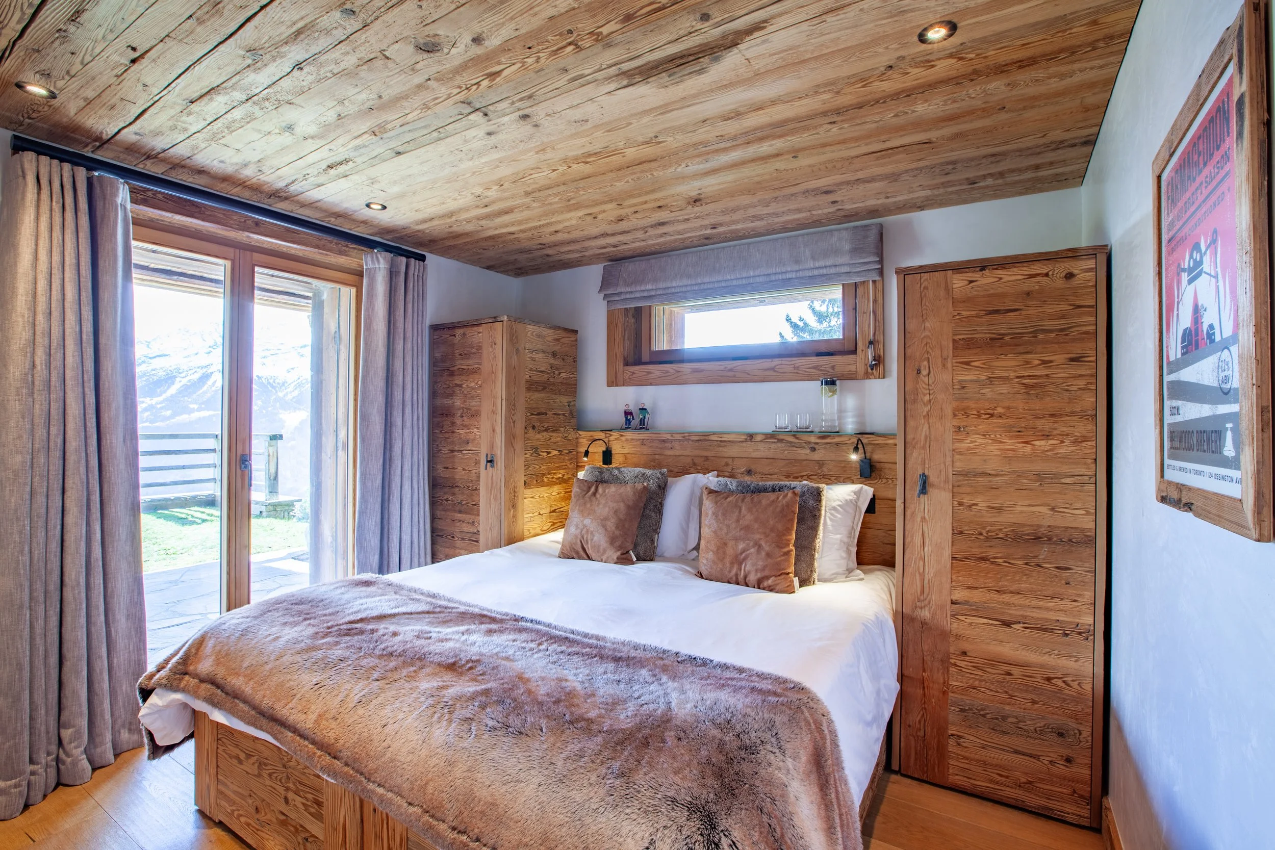 Guest bedroom with king size bed splitting into twin singles and panoramic Alpine mountain views, Chalet la Vigne Verbier luxury ski chalet Switzerland