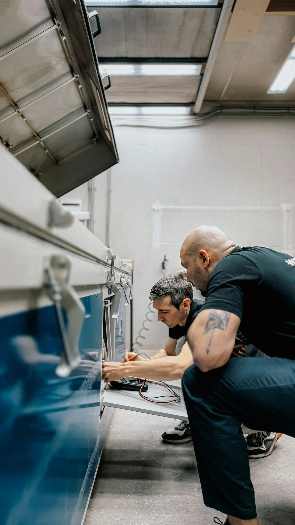 Two men working together on technical equipment