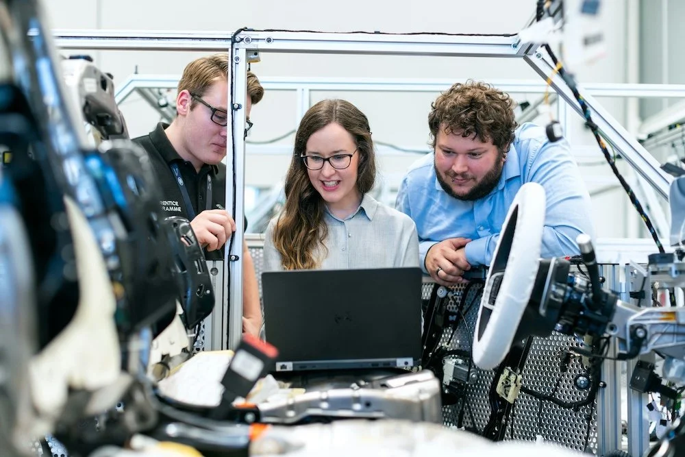 Group of experts working together on technical equipment