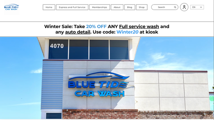 Exterior of Blue Tide Car Wash building with sign and promotional banner for winter sale, offering 20% off on full service wash and auto detail using code Winter20.