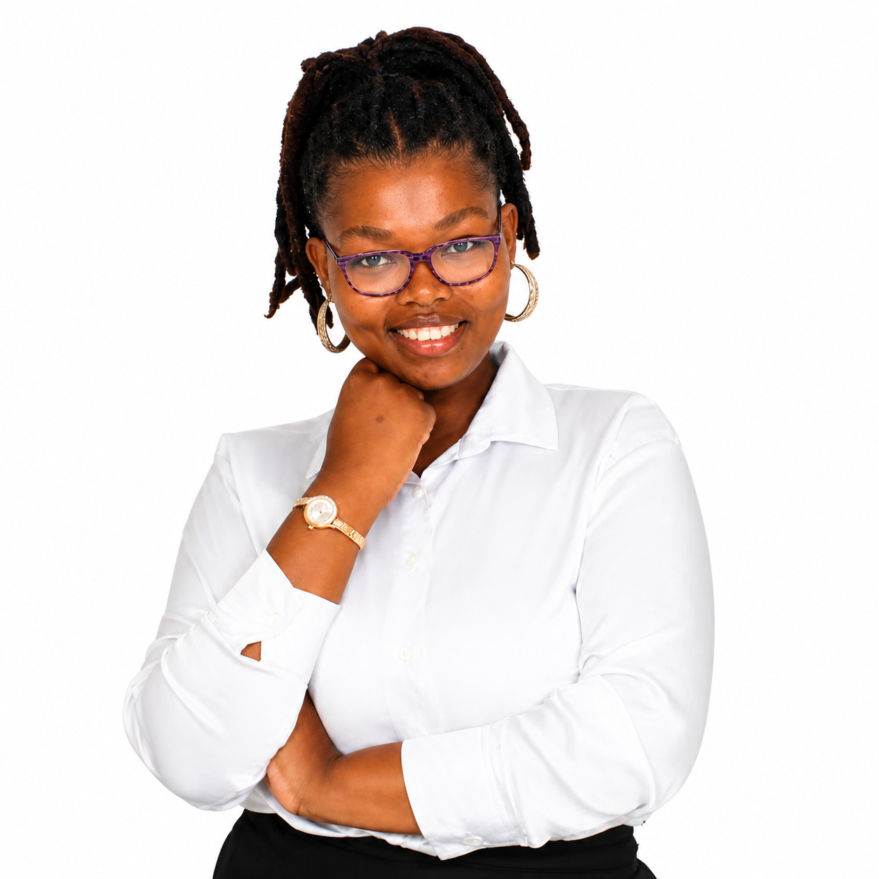 Portrait of a smiling Black woman with dreadlocks, wearing glasses, a white blouse, a gold watch, and hoop earrings, posing with her hand near her chin against a white background.