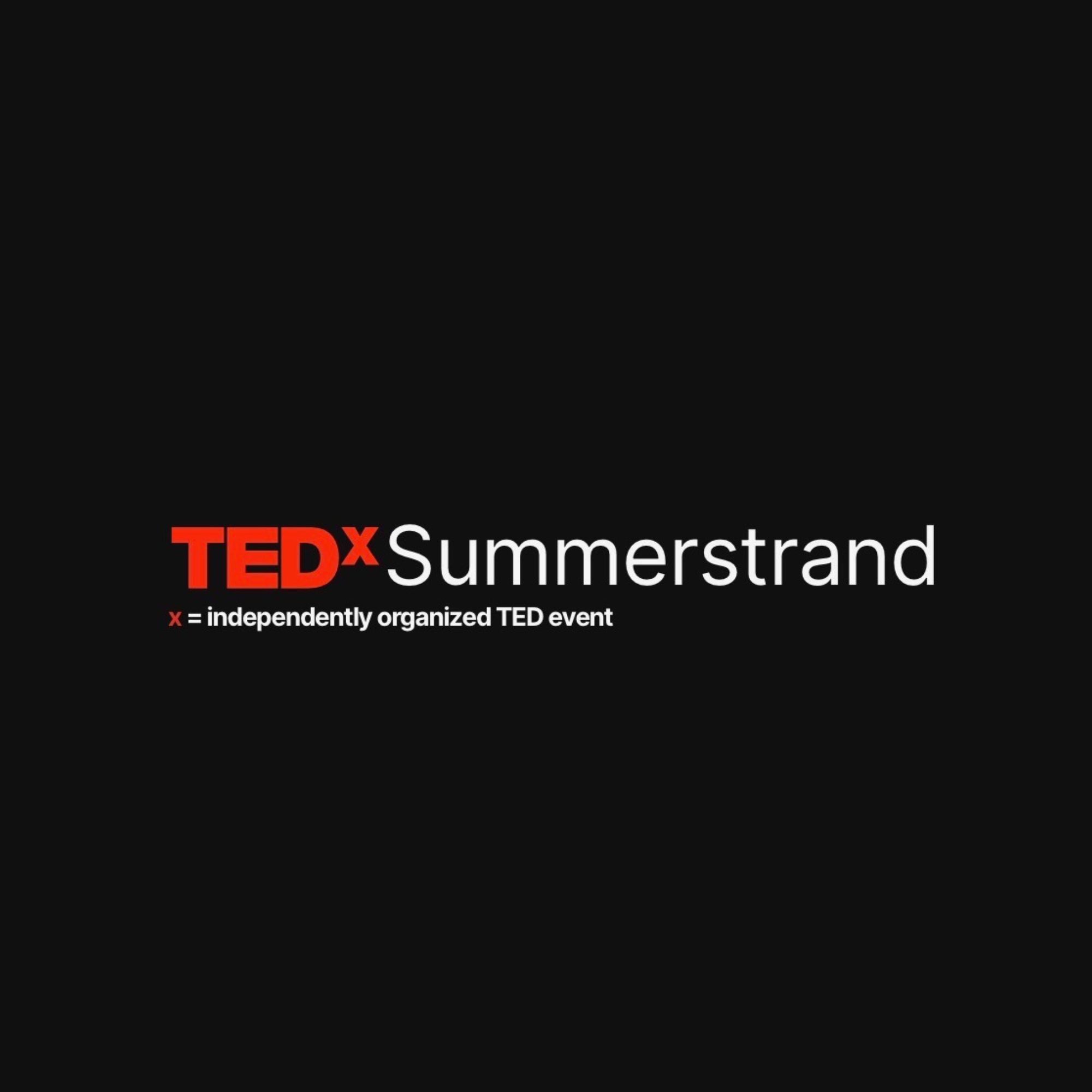 Fake TEDx Sign with red and white text on black background.
