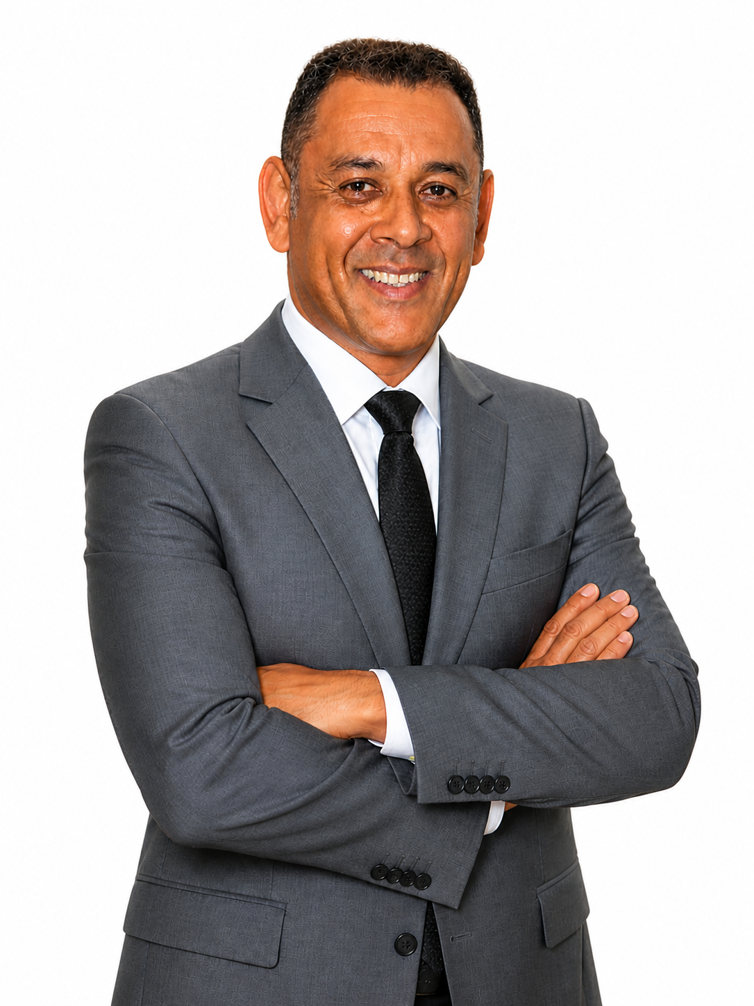 Man in a gray suit with a black tie, arms crossed, smiling, against a white background.
