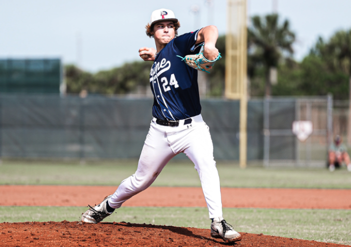 A baseball pitcher on the mound preparing to throw a pitch during a game.