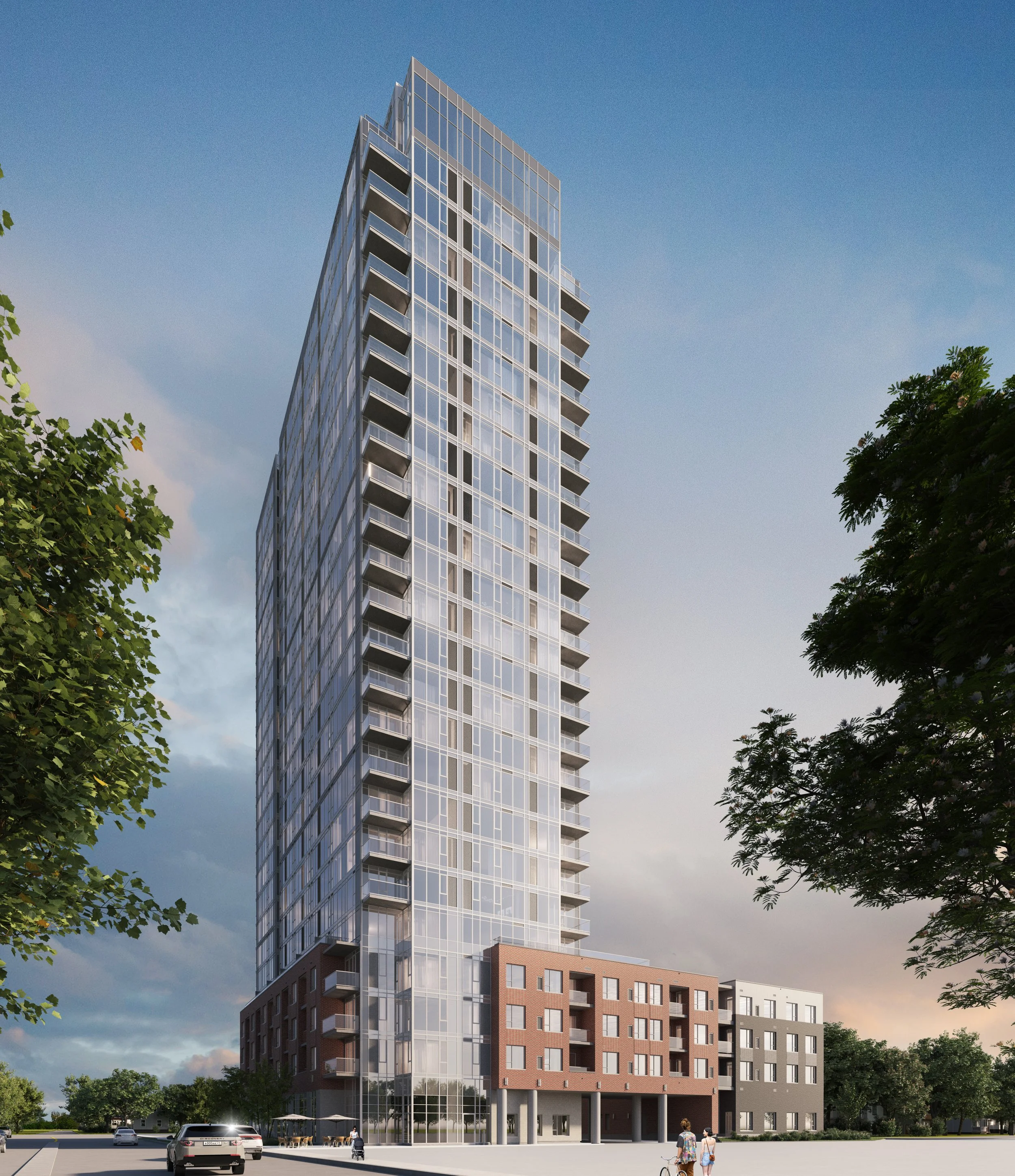 Modern high-rise building with glass windows and balconies, with trees and cars in the foreground and a partly cloudy sky in the background.