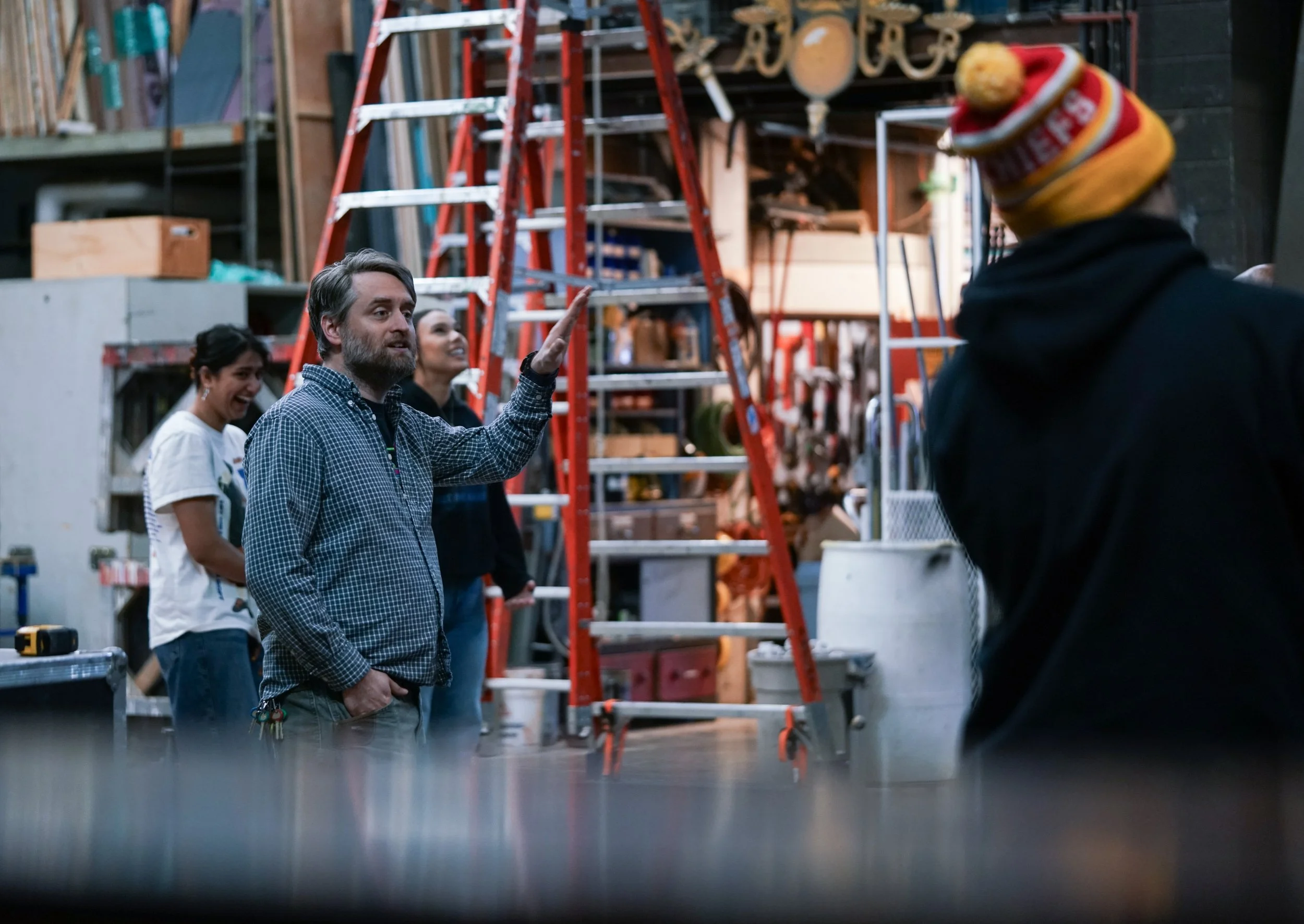 Zach Alley gives instructions to students as they remove set pieces from the previous production of “Silent Sky.”

