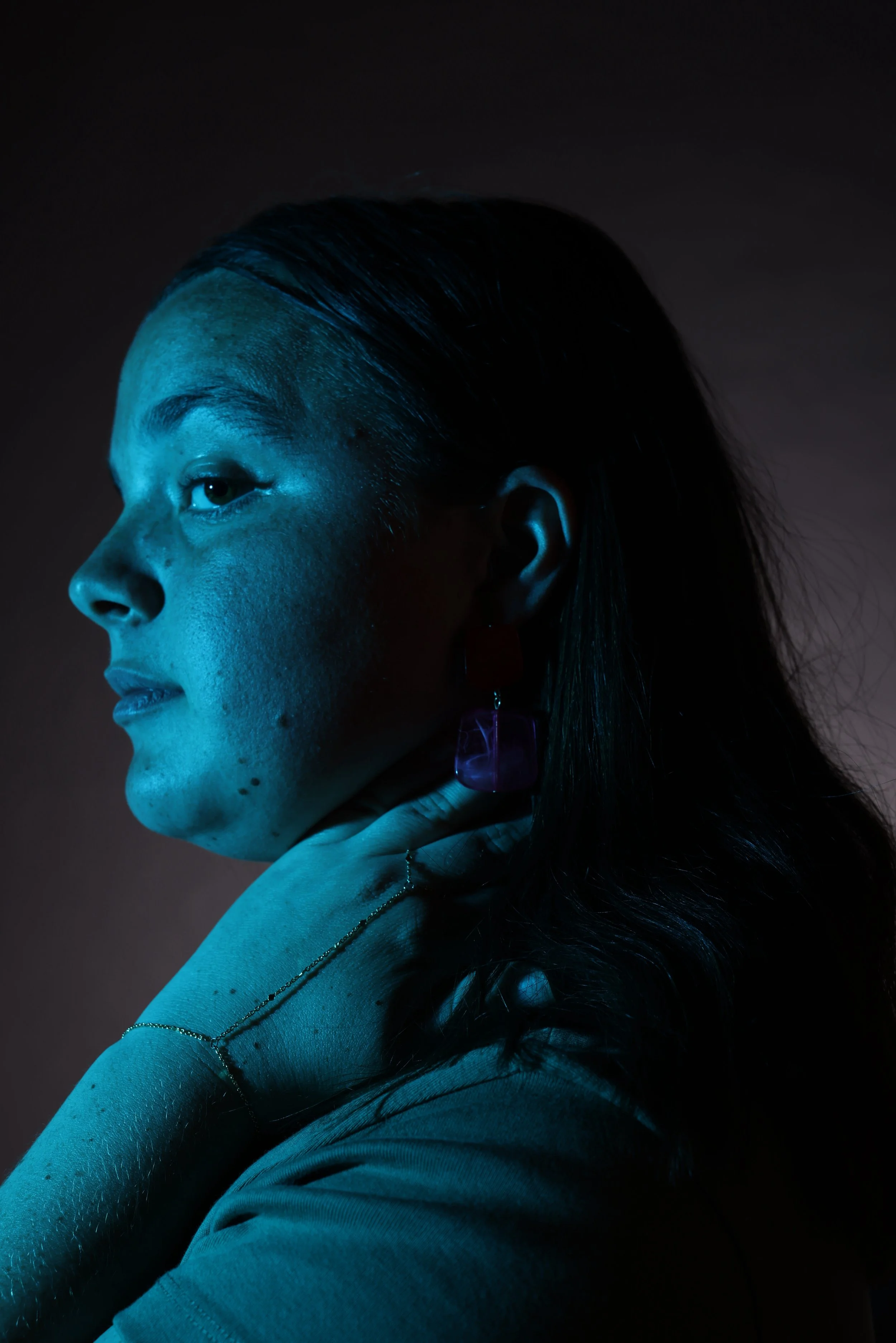 Elsa Connolly, 25, poses for a studio portrait on March 31 in Columbia, Mo. Connolly, who said she
owns “over 20 pairs of earrings,” draws inspiration from her grandmother. “My Grandma used to wear
the craziest jewelry and I was always drawn particul