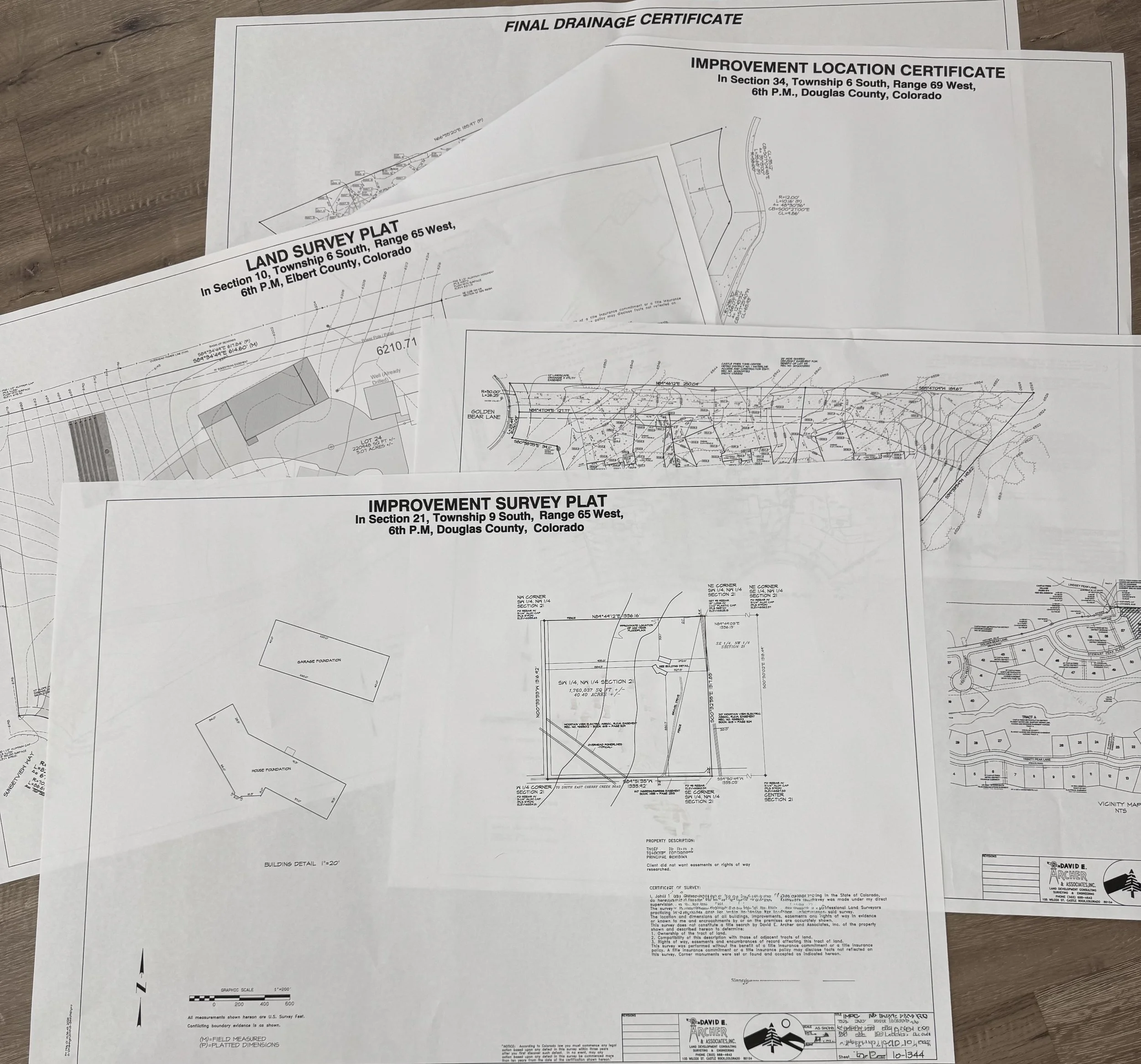 Overlapping survey and engineering plans for land development, including drainage, improvement, and survey plats with detailed site layouts and measurements.