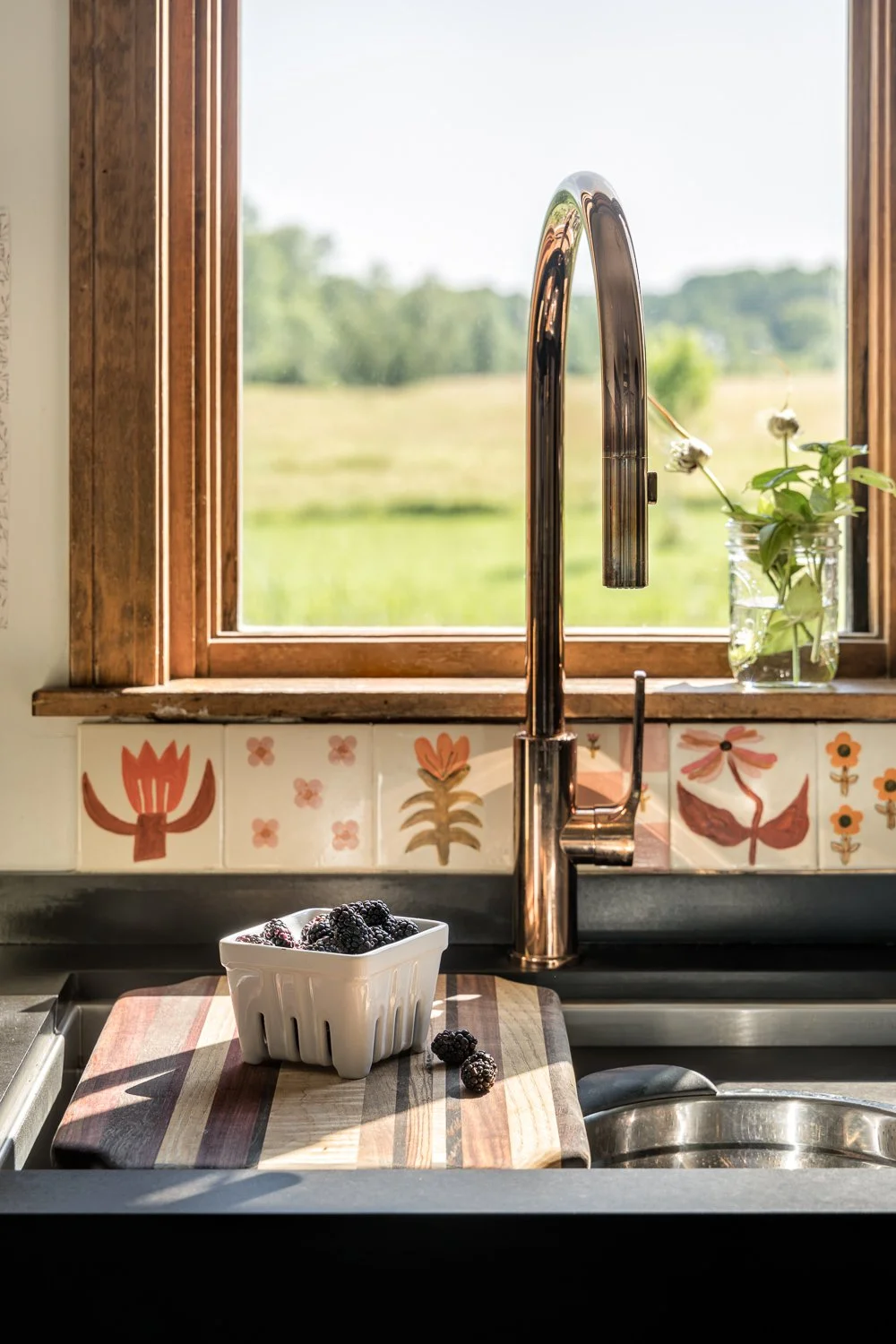 Close up of tile and faucet in eclectic kitchen in Pownal, Maine