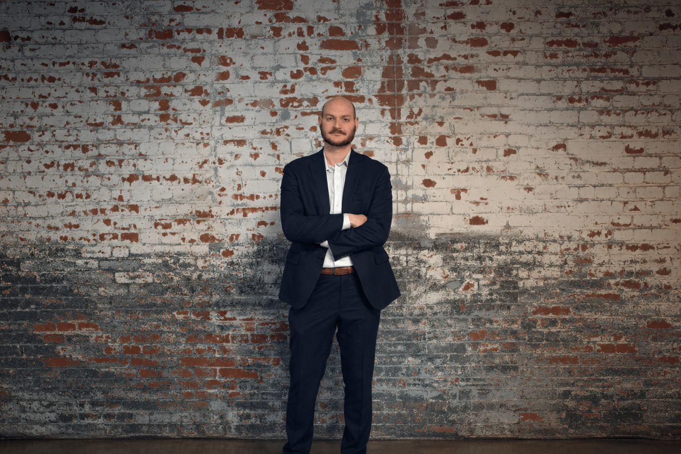 Democratic candidate for Pennsylvania State Representative in Berks County standing against brick wall, professional campaign portrait. Pennsylvania State House District 5, Andres Santiago.