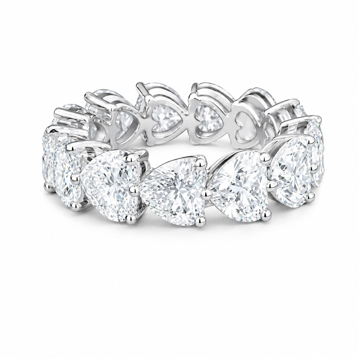 Silver ring adorned with large heart-shaped and pear-shaped clear diamonds arranged in a floral pattern.