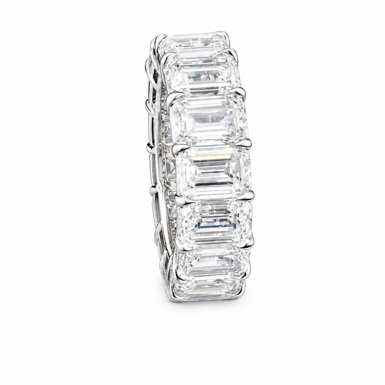 A silver ring with large, rectangular-cut diamonds set in a continuous pattern.