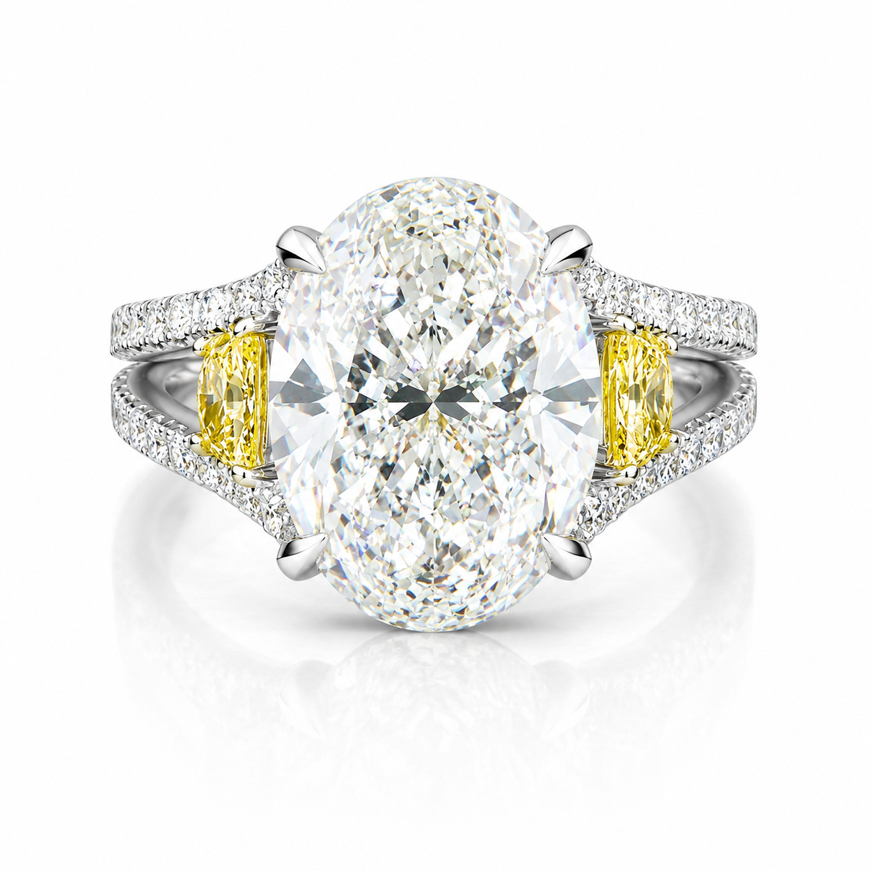 Close-up of a large diamond engagement ring with smaller diamonds on the band and yellow accents on the sides.