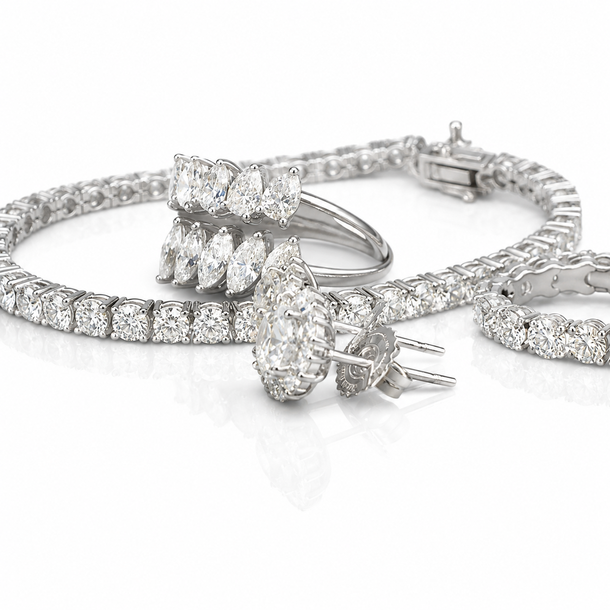 Set of diamond jewelry including a ring, earrings, and two bracelets with sparkling stones over a white background.