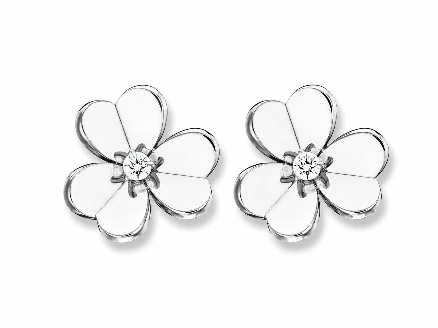 Pair of silver flower-shaped earrings with a central clear gemstone on a white background.