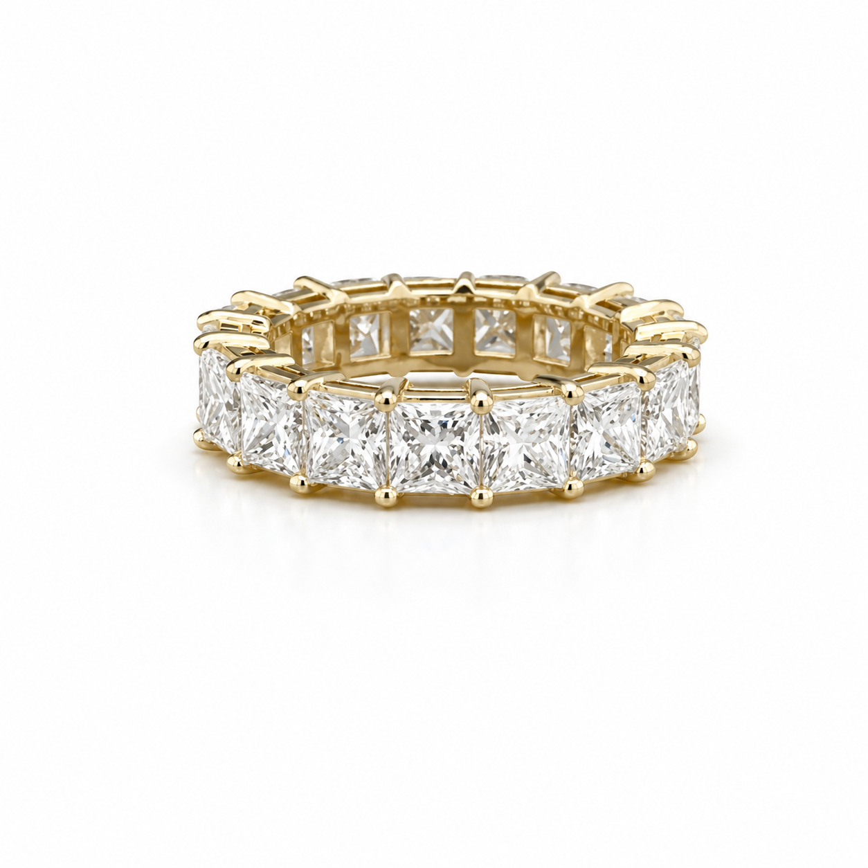 A gold eternity band set with square-cut diamonds.