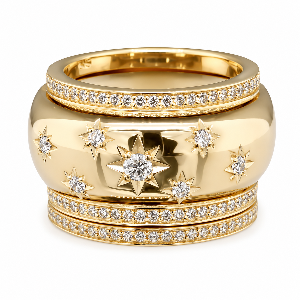 Gold jewelry set including a ring and a wide cuff bracelet decorated with diamonds and star-shaped embellishments.
