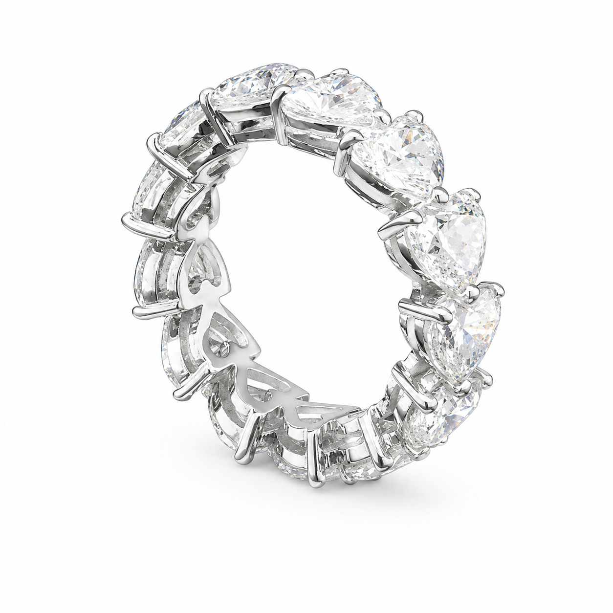 A silver ring with multiple large heart-shaped clear gemstones and intricate leaf-shaped designs on the band.