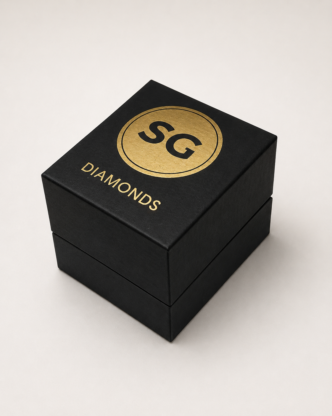 A black jewelry box with a gold circular emblem containing the letters 'SG' and the word 'Diamonds' on top.