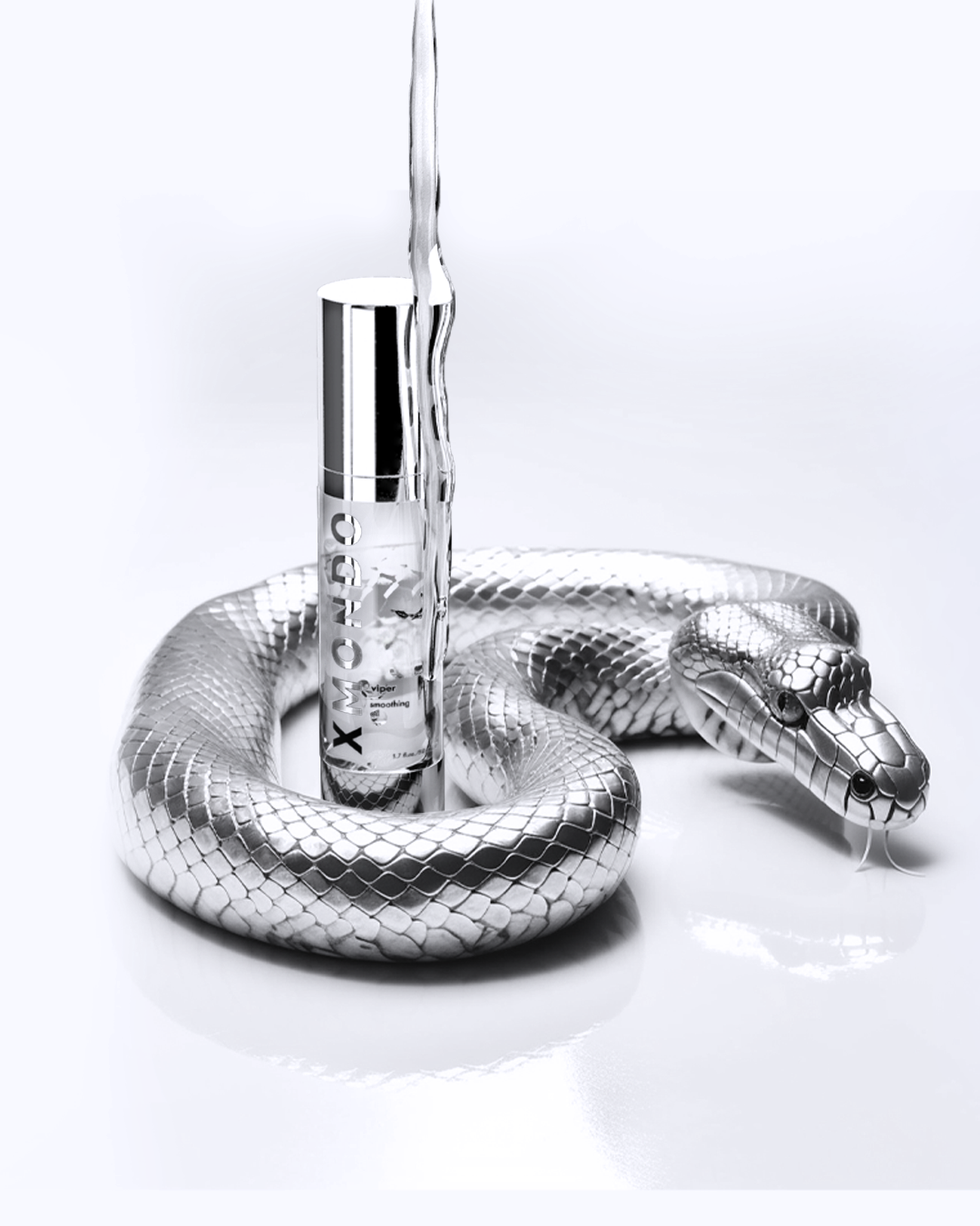 A silver, metallic snake coiled around a tube of X Moisturizing serum with a pipette tip, set against a white background.