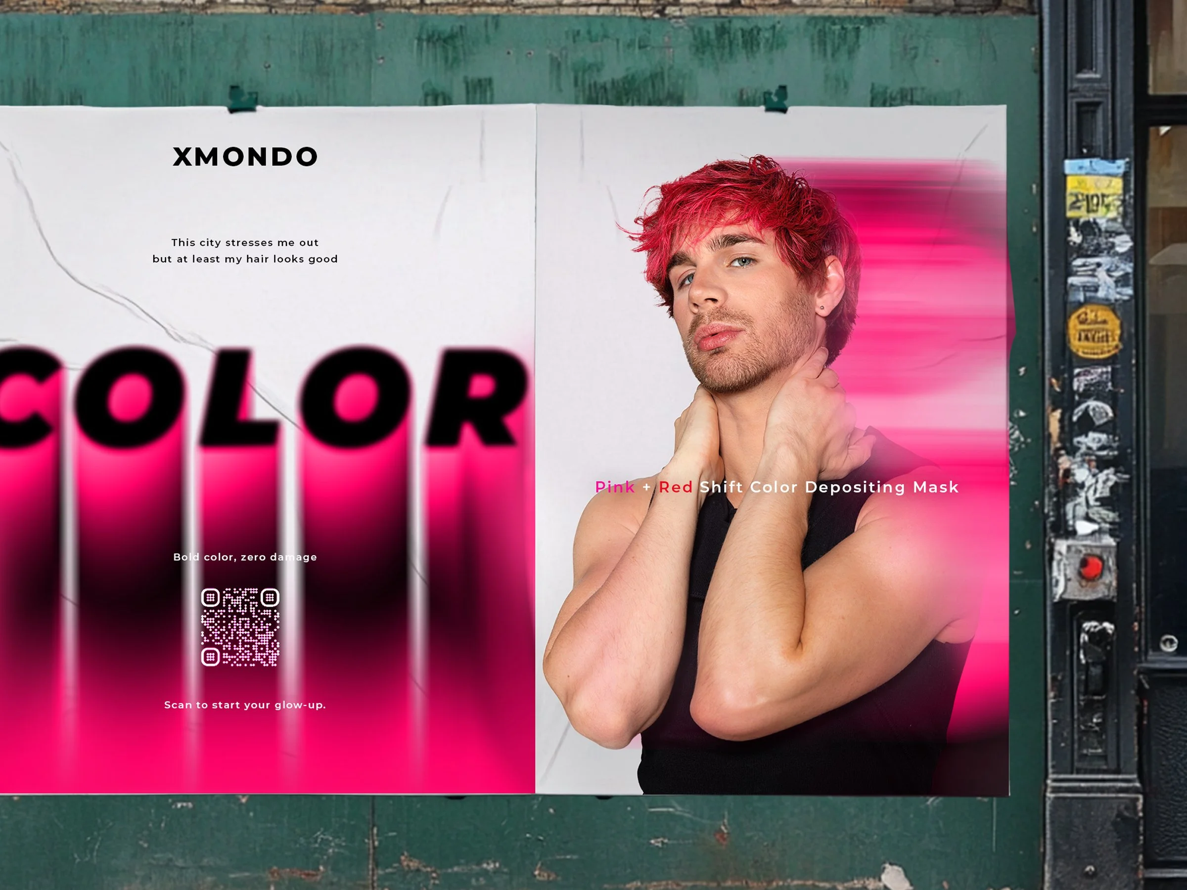 A young man with pink and red dyed hair posing with his hand near his neck, standing in front of a large pink background and a white poster on a green surface, with a newspaper rack and street scene visible on the right side.