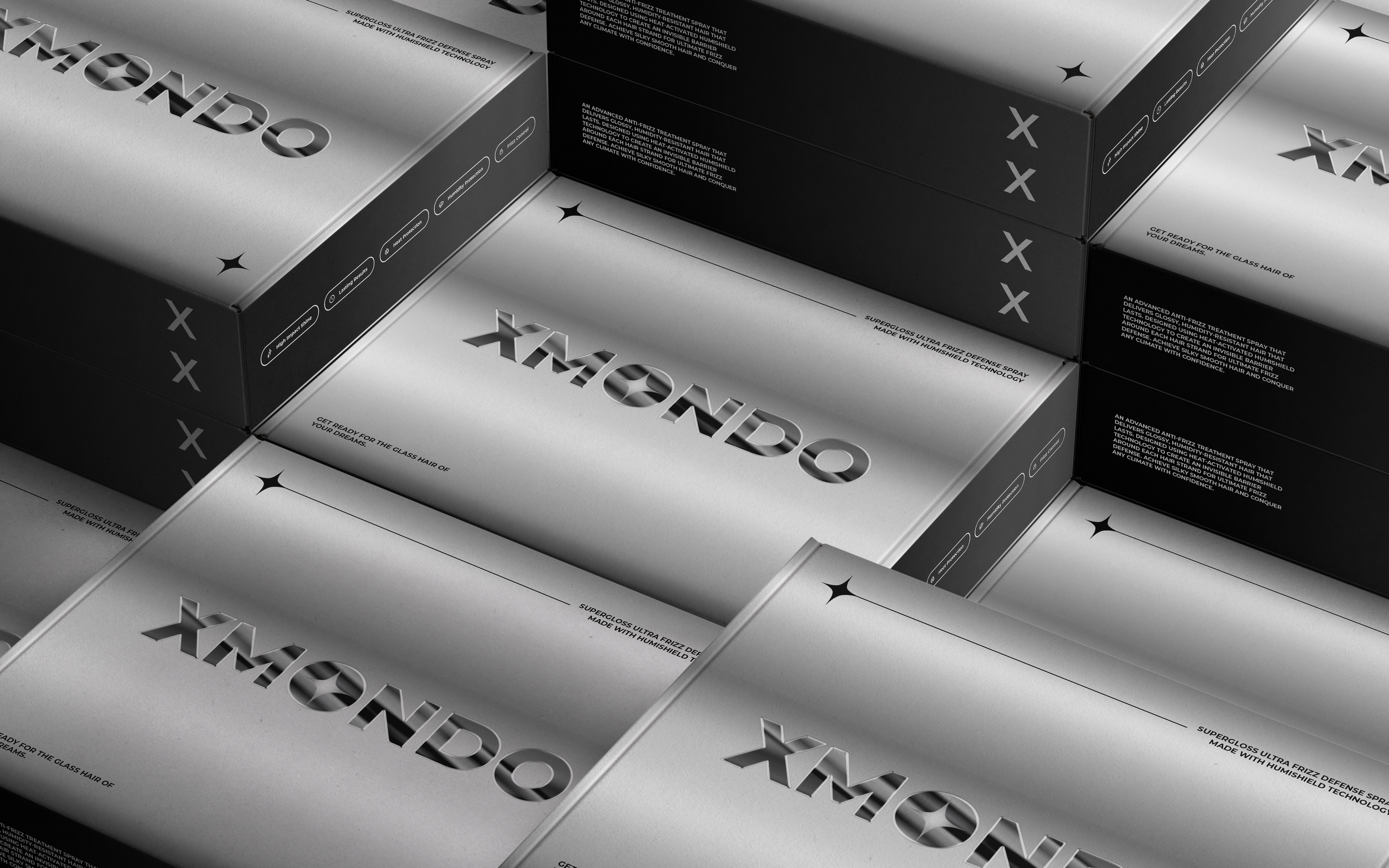 Multiple silver boxes with the word 'XMONDO' embossed in 3D, arranged in a pattern, with some black boxes with white text, featuring product descriptions and branding.