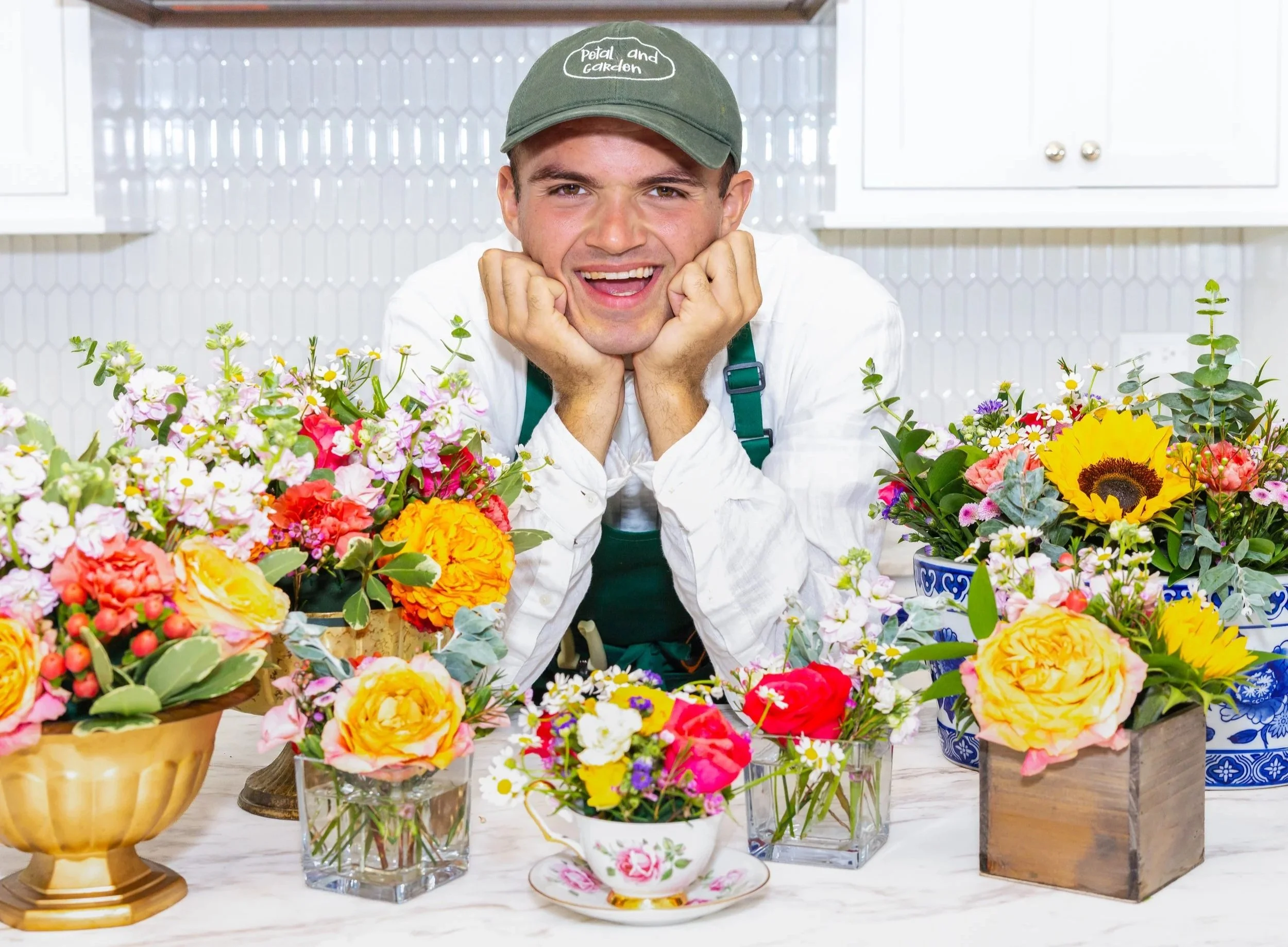 Sean with several of his flower arrangements.